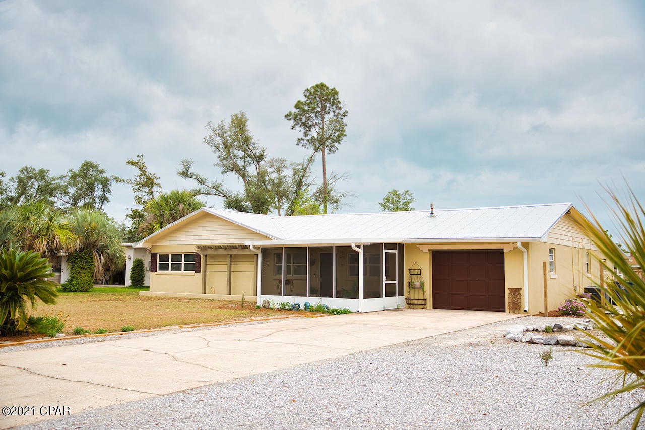 Nice 4 Br 3 Ba, 2 living rooms, 2 dining rooms, 2 kitchens- Seller Offering 10k New Window Allowance to Buyer!   Not in a flood zone. The home is located on a large lot that includes 10+ parking spaces. It has a newer metal roof and 2 skylights, the floors are ceramic tile, luxury vinyl and carpet. The interior is newly painted. It has spacious rooms and a large master bedroom with a sunroom and extra large master bath. There are 2 new central heat and air units, a wood burning fireplace, a screened in porch, large covered porch, one car garage, washer and dryer hookup and an irrigation well. (sprinkler system not warranted)

Bonus: 10'x20' - 200 sq ft. workshop /storage building with electricity, man/woman cave, or a children's play house or maybe a teenager getaway. No homeowners assn.