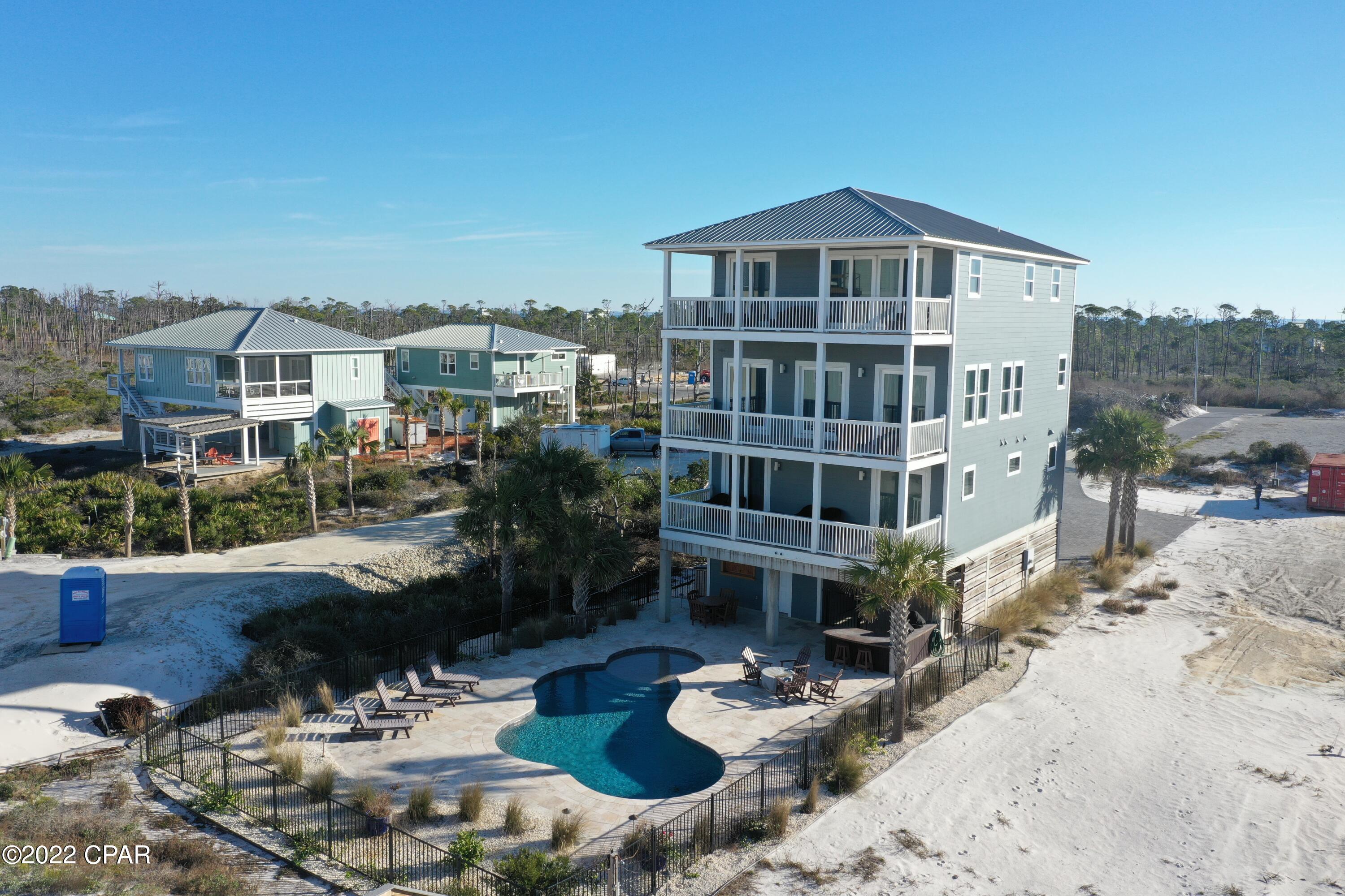 Incredible custom beachfront home on North Cape San Blas that's loaded with extras and every feature you'd want in a beach house. Oversized parking with private entrance, beach boardwalk, gorgeous heated pool, elevator, propane fire pit, outdoor kitchen with 2 Green Eggs, downstairs/pool bathroom, outdoor shower, large ice maker, high end kitchen and much more. It was strategically built a little further from the beach for extra security from storms and erosion. This home has been refreshed since Michael and appears in perfect condition and sold mostly furnished and equipped. Amazing kitchen/living/dining on the 3rd floor with great views and a master to die for on the 4th complete with a sitting area and separate office. Check out virtual tour. Never on rental program but Cape and Coast project approx $232k