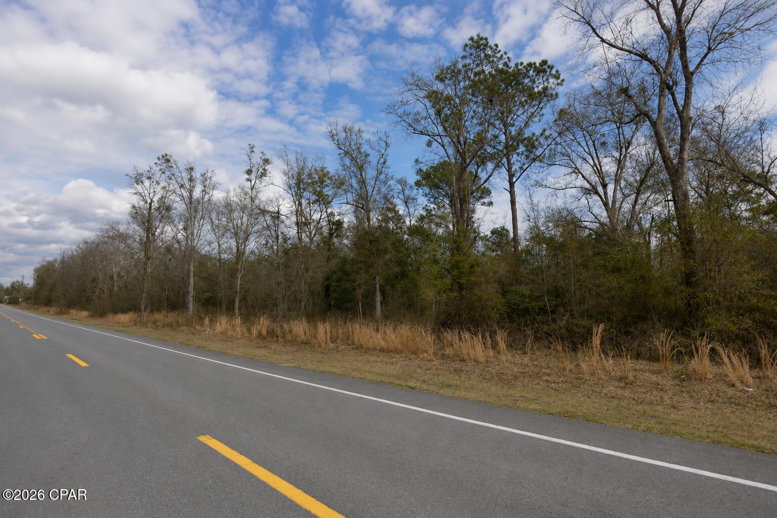Build your dream home or country getaway in the quiet, highly sought-after community of Seven Springs Lake! This prime, build-ready 0.66-acre homesite (Parcel ID: 02624-280R) features excellent paved road frontage for clean, easy access. Nestled in a peaceful, golf cart-friendly neighborhood, the lot offers a perfect blend of privacy and community charm. Outdoor enthusiasts will love the location--you are just minutes from downtown Wewahitchka, local schools, and shopping, and less than a mile from the Chipola River and Lands Landing boat ramp for world-class freshwater fishing and boating. Best of all, you are a straight 20-minute drive down to the white-sand beaches of Port St. Joe and the Gulf. Low annual HOA fees, electricity and city water available in the area, and no timeline to build make this the perfect investment. Bring your builder, your boat, and your vision to Gulf County today!