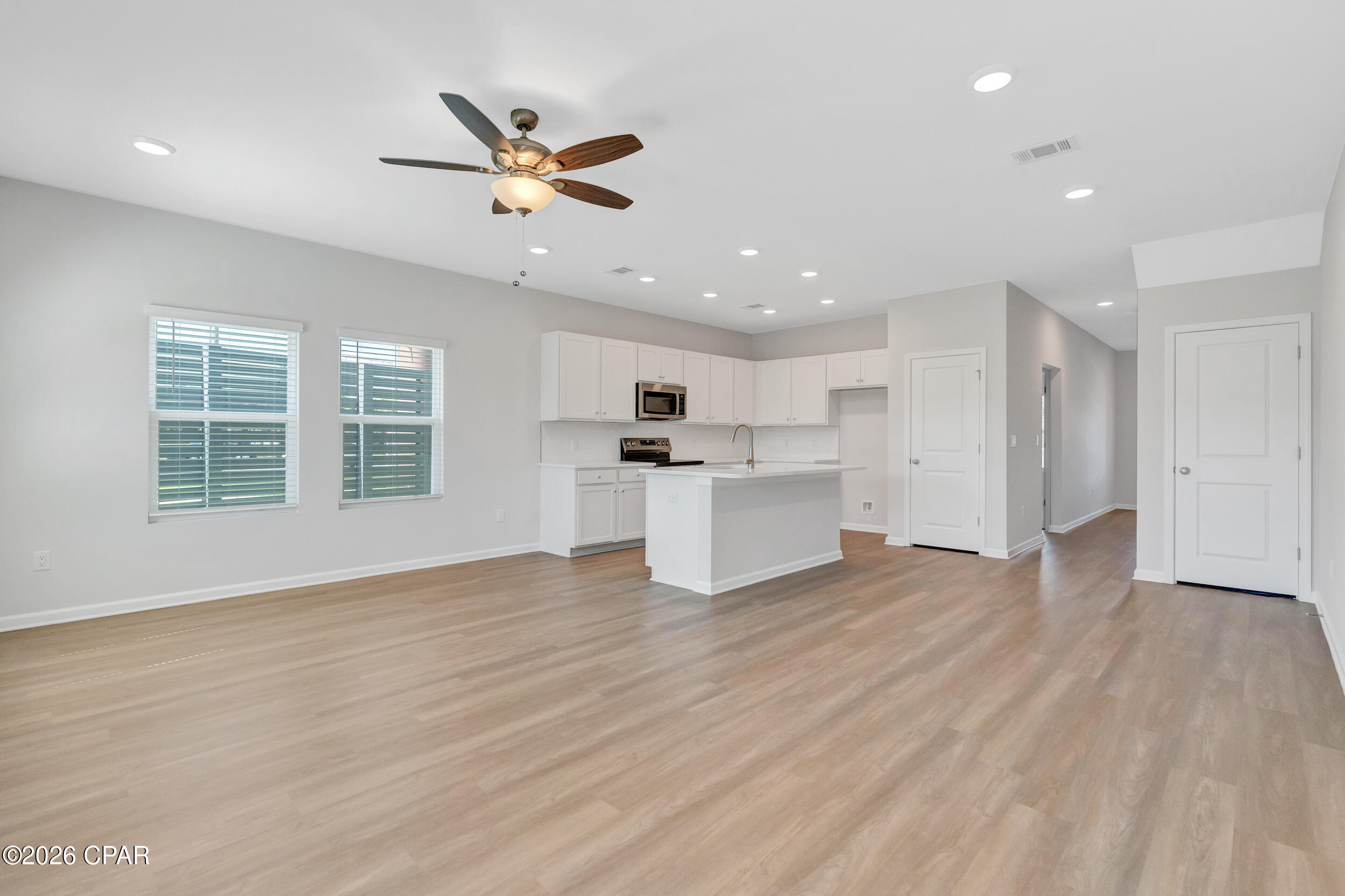 NO RENTAL RESTRICTIONS!!! Waypoint by Traton Homes, a vibrant new community of townhomes located on Front Beach Road in Panama City Beach, Florida. Waypoint offers 72 homes just under 3 miles from the beach, 1.5 miles from Dolphin Bay, and approximately 20 miles from the Northwest Florida Beaches International Airport. Residents will enjoy easy access to local attractions, with Pier Park only 7 miles away and Hathaway Bridge nearby, serving as the gateway to Panama City proper. The community is also conveniently situated near the Naval and Coast Guard bases.  Each townhome features 3 or 4 bedrooms, including a bedroom with a full bath on the main level. The open concept living space includes a modern kitchen with an island, a dining area, and a family room that opens to a private back patio. Upstairs, the spacious owner's suite offers a walk-in closet, and an ensuite bath with a double vanity, a shower, and a separate water closet. Two additional bedrooms, an additional full bath, and a conveniently located laundry room complete the upper level.