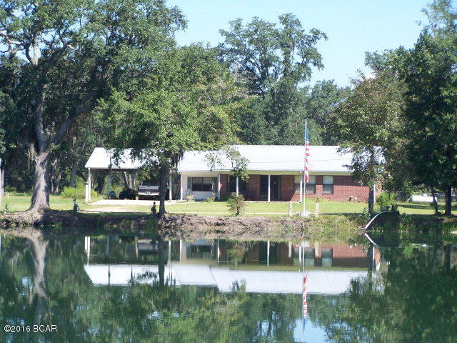 19.69 BEAUTIFU ACRES, Pasture, Huge Oak trees 5 AWESOME FISH PONDS! Well maintained and updated brick home. 2020 heated sq ft, 3br/2b's, Double Pane windows, C/E heat n cool, laminate wood flooring, nice large kitchen with eat in area, bonus room with built in cabinets, large Family room with gas fireplace unit, large screen porch and fenced back yard for pet. Pole barn, shop with concrete floor and electricity. Great for horses and great fishing. Check out the pictures of the property, ponds and home.