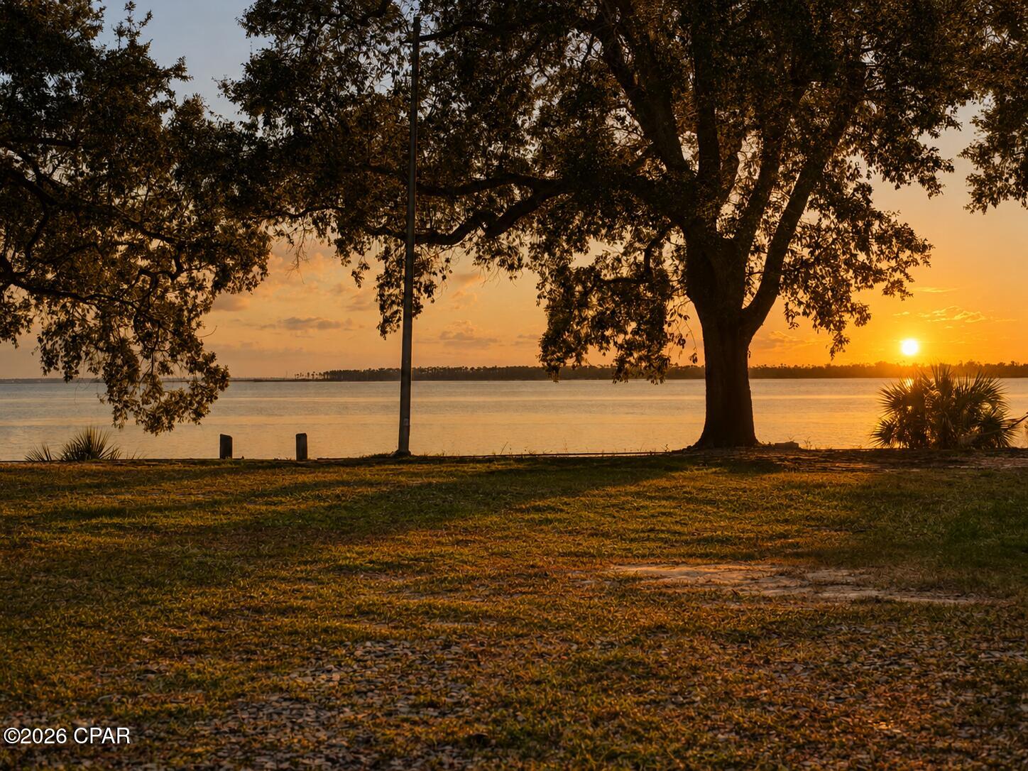 Enjoy exceptional waterfront living on this stunning .75-acre property featuring 90 feet of bay front along beautiful East Bay in the heart of Bay County, Florida. The property also includes an oversized double garage, offering plenty of additional space for vehicles, storage, hobbies, and more.
Privacy fencing creates a peaceful retreat where you can relax and enjoy the waterfront views, while a sprinkler system helps maintain your landscaping and garden.
This property offers an unbeatable lifestyle location. Sidewalks provide easy access to two nearby parks, including a public pier, walking trails, a large wooded playground, and a Frisbee golf course--all within walking distance. Directly across the street, enjoy a wide variety of restaurants, cafés, bakeries, coffee shops, and dining options, including Thai, sushi, Italian, and more. A nearby full-service marina offers charter fishing excursions, waterfront dining, a tiki bar, and opportunities to gather and socialize.
Zoned Mixed-Use, this property presents opportunities beyond personal enjoyment. Whether you envision a private waterfront retreat, short-term rental investment, multifamily development, townhomes, apartments, or up to 12 units, the development potential is substantial. Its prime frontage along Tyndall Parkway, with thousands of daily passing vehicles, also makes it a potential location for retail, hospitality, restaurant, or other commercial uses.
Rarely does a property combine waterfront beauty, walkable amenities, flexible mixed-use zoning, and significant development potential in one offering. Whether you're seeking a waterfront homesite, income-producing investment, or development opportunity, this East Bay property offers a variety of possibilities.
Some photos have been modified using AI. Buyer to verify all information deemed important.