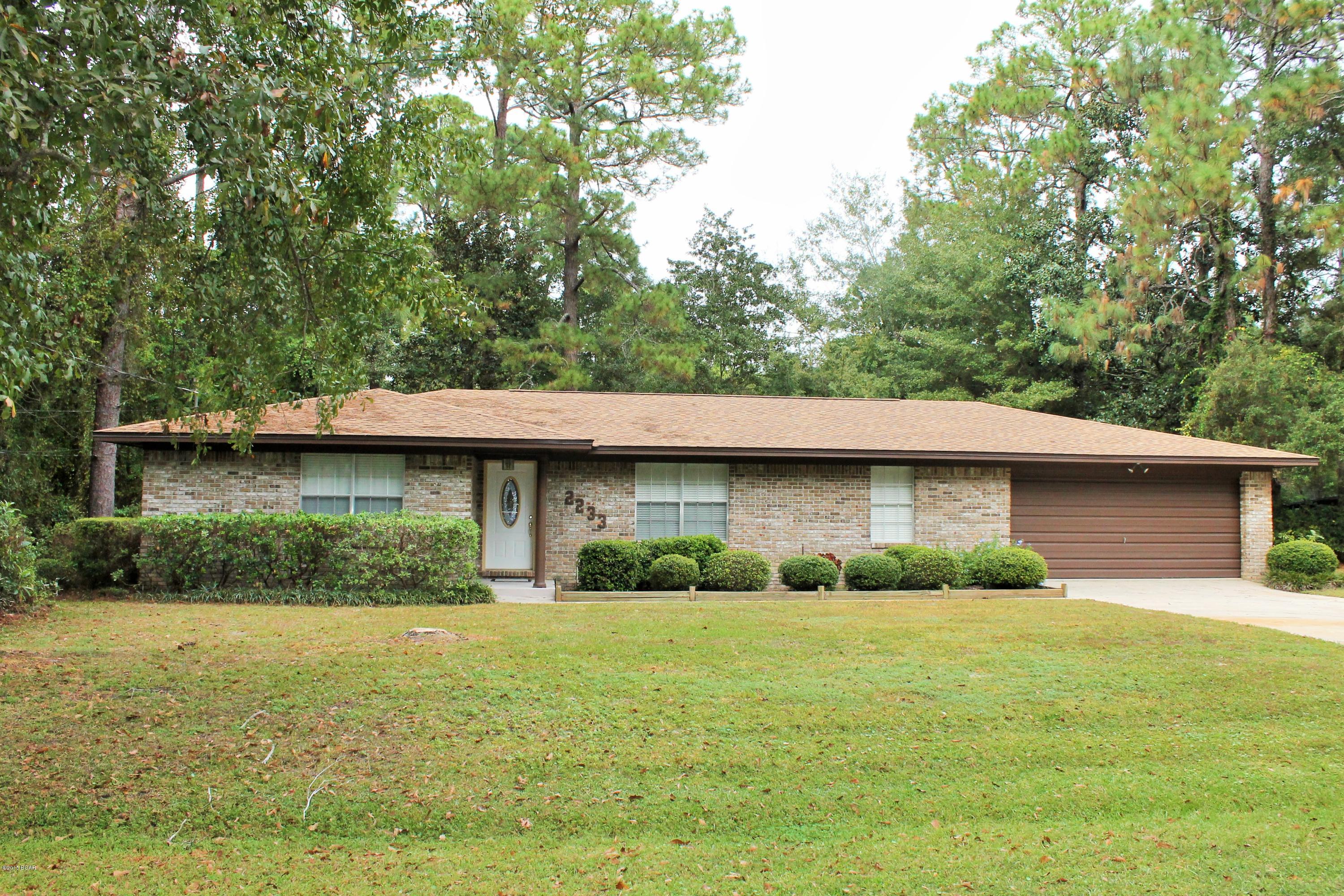 This lovely ranch style 3 bedroom 2 bath brick home in College Point awaits you! The main living area features the kitchen and breakfast area open to the Cozy Family Room featuring a brick fireplace. The formal living room and dining room are combined giving you a large space for entertaining. All three Bedrooms are at one end of the home, master has bath with double vanities, additional bath for other two rooms and guest. Other features are a 2 car garage, covered porch, yard bld., deck with trellis and the best is the htd/cld Florida room! Lots of perks to this home location(just a couple blocks from the neighborhood park on the water), schools, shopping, restaurants,  convenient to Tyndall Air Force Base and much more! *Additional lot next door sold separately call for more information. Call for more information on the additional lot. All room sizes approximate. Please verify if important.