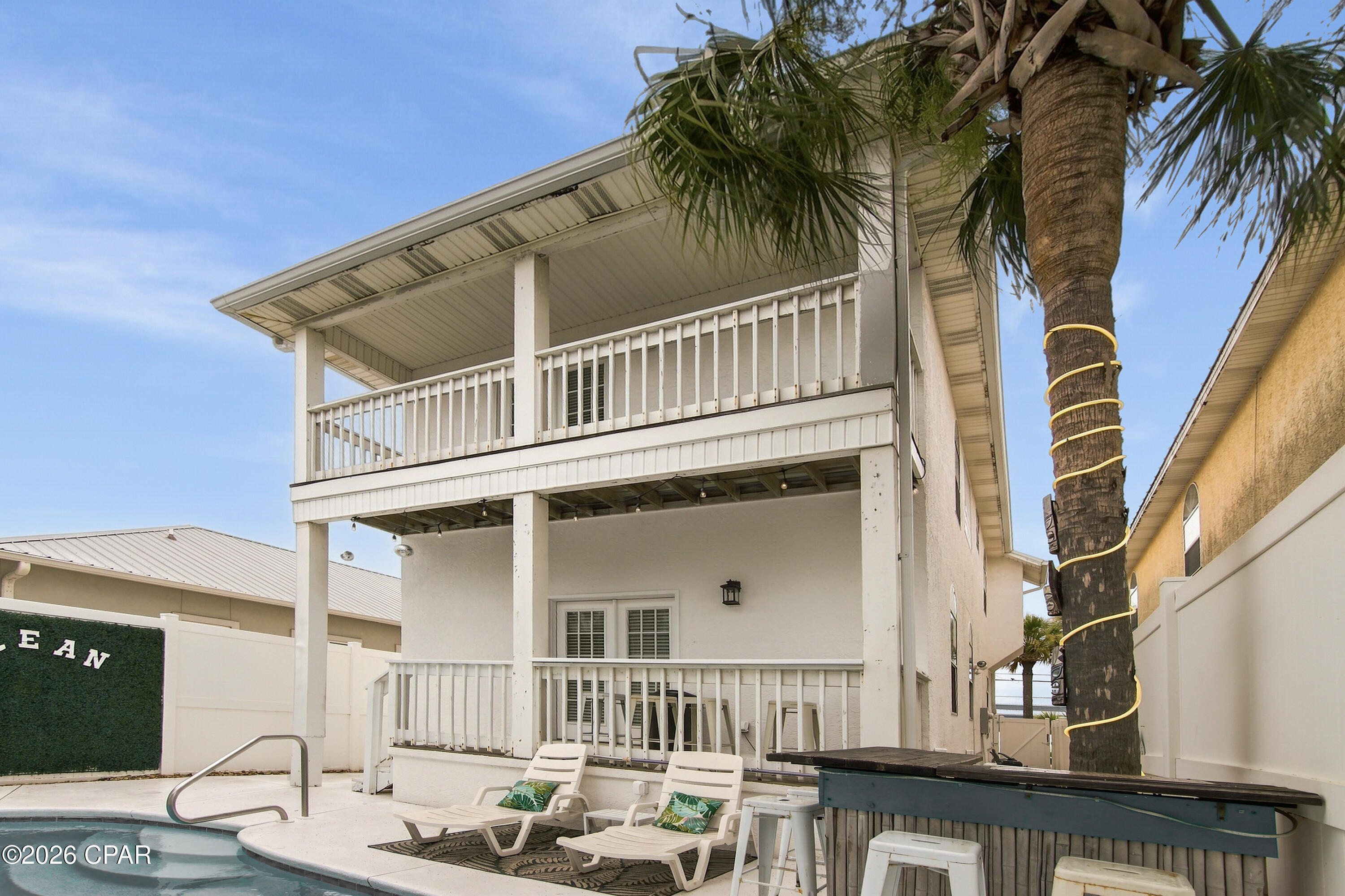 Just one block from the white sandy beach! Located withing walking distance to public beach access 18. Looking for your next rental? This home is  currently bringing in $90k per year rental income. Whether looking to live in or rent the location can not be beat! The home has everything you could think of for maximizing rent including a pool, gaming, balconies for sunset and sunrise watching. Located on the East end near Surf Dr. The garage has been transformed into a game room. It can be converted back. Sq ft is approximate due to garage conversion. Originally 1600 sq ft with garage. No HOA! 
Video to come soon.