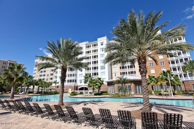 VIEWS FOR DAYS! This penthouse condo is located in Reflections at Bay Point.  This unit is a 3 bedroom 3 bath 7th floor penthouse condo with a massive wrap around balcony that gives you amazing views of Grand Lagoon overlooking the Nicklaus #5 ''Fly-Over'' green towards Shell Island.  This unit also features a large master bedroom suite with a large walk in closet with built in cabinetry.  The main living area features columns, tray ceilings, double set of sliding glass doors leading to the wrap around balcony and lots of windows to enjoy the views.  Open kitchen with large breakfast bar leading to formal dining are and/or den that adjoins the 3rd bedroom with a private screened balcony over looking the lagoon.