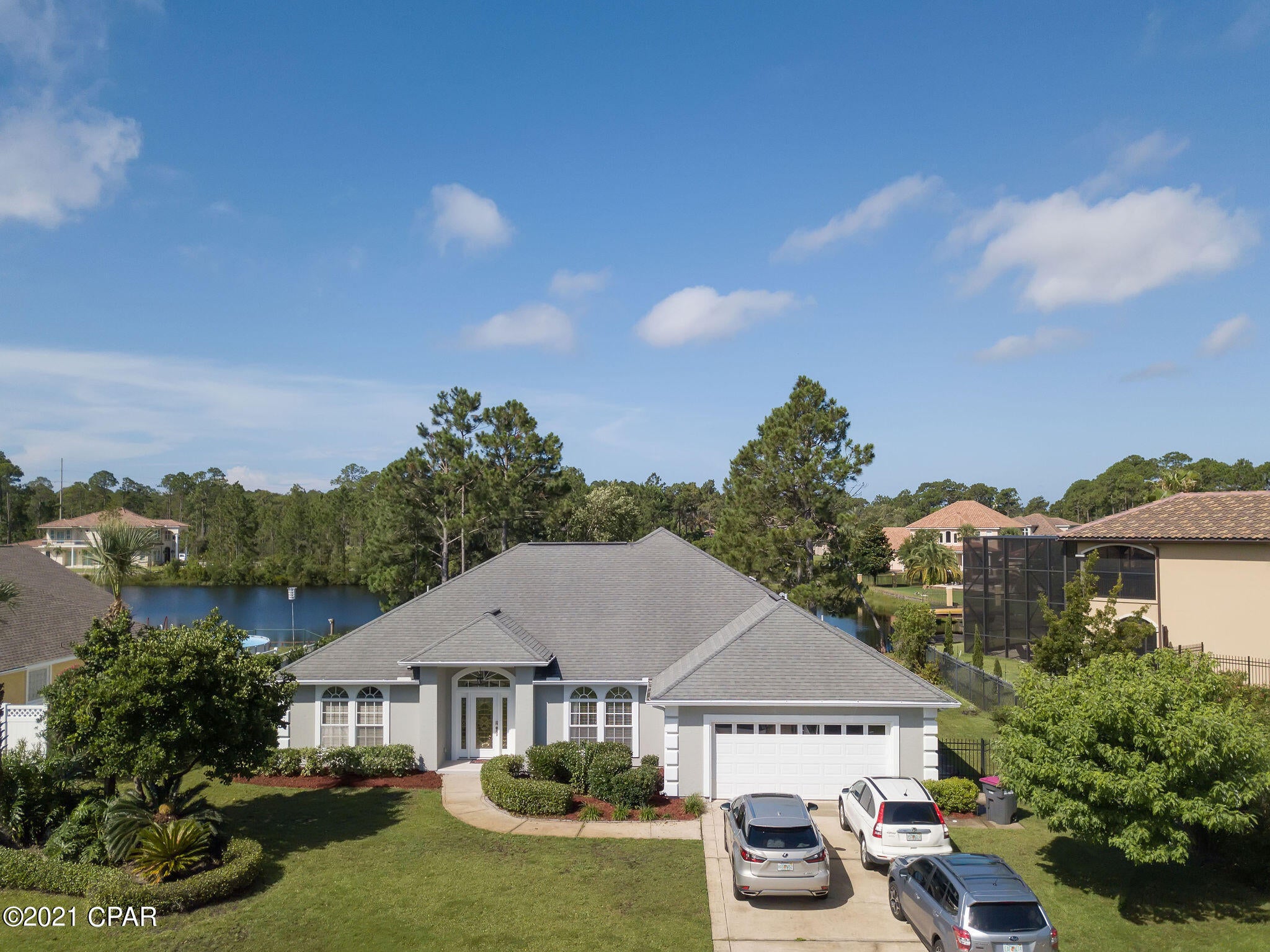 CURRENTLY UNDER CONTRACT, SELLER ACCEPTING BACKUP OFFERS Waterfront living at its best with beautiful views of Lake Marion in the quiet North Colony Club Estates! This is a 3 bedroom, 3 bathroom custom built home with an office and separate dining room that has been lovingly taken care of and upgraded by the current owners. Upgrades since 2017 include a full remodel of master bath, quartz countertops throughout, wood tile flooring, interior paint, upgraded light fixtures and ceiling fans, new carpet in bedrooms, new GE appliances in kitchen, tankless water heater, screening on patio to protect from noseeums and more!! Split floorplan provides privacy with master bedroom and first guest bedroom both having fantastic views of the water. Sit on the screened back porch and watch the wildlife or try your luck at catching a fish from your small dock. This is a very unique waterfront home in a unique section of Panama City Beach. Colony Club is a very established neighborhood with no HOA fees and is situated in the heart of PCB but is far enough off the main roads to give a sense of quiet and seclusion. This home has everything you could want and will not last long, schedule your showing asap!