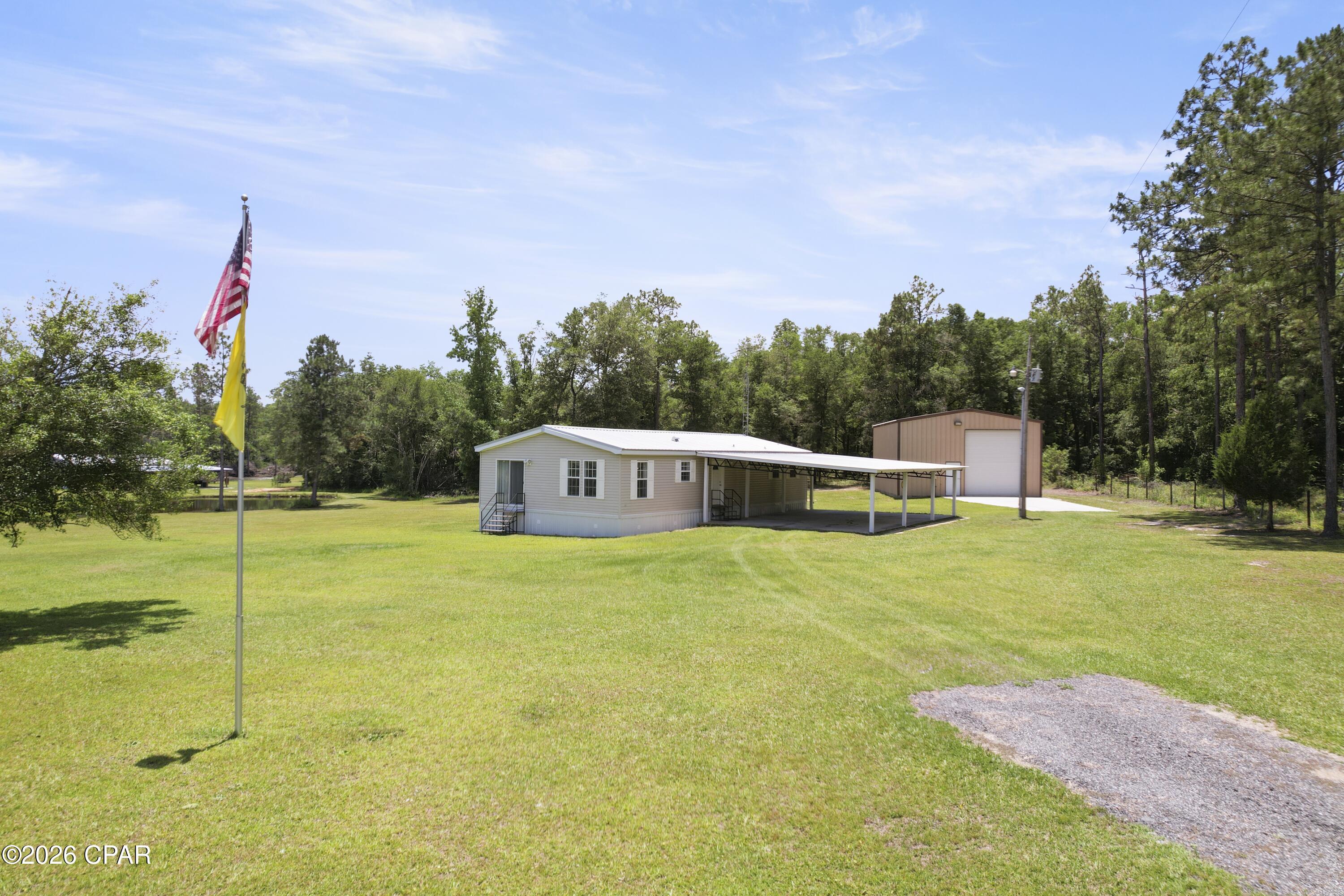 Discover the perfect blend of space, privacy, and potential with this 4.67 acre property with a move in ready home. Nestled in a peaceful setting, this expansive lot offers endless opportunities. Whether you are looking to enjoy country living, start a small farm or homestead or just enjoy a laid back lifestyle. The home provides comfortable living with 2 Bedrooms and 2 Baths. It also features an open layout with plenty of natural lighting. The home has many upgrades. Roof was installed in 2022 and the well has just been installed this past year. This property also features a 30 x 40 steel building with electric. This will make a great workshop and still have room for all the extras. Seller is offering a $1,000.00 towards new flooring,$500.00 towards New Hot Water Heater and will pay for the septic to be pumped. Making a great start for the new owners. Don't miss this unique opportunity to own acreage with a home. Schedule your showing today!