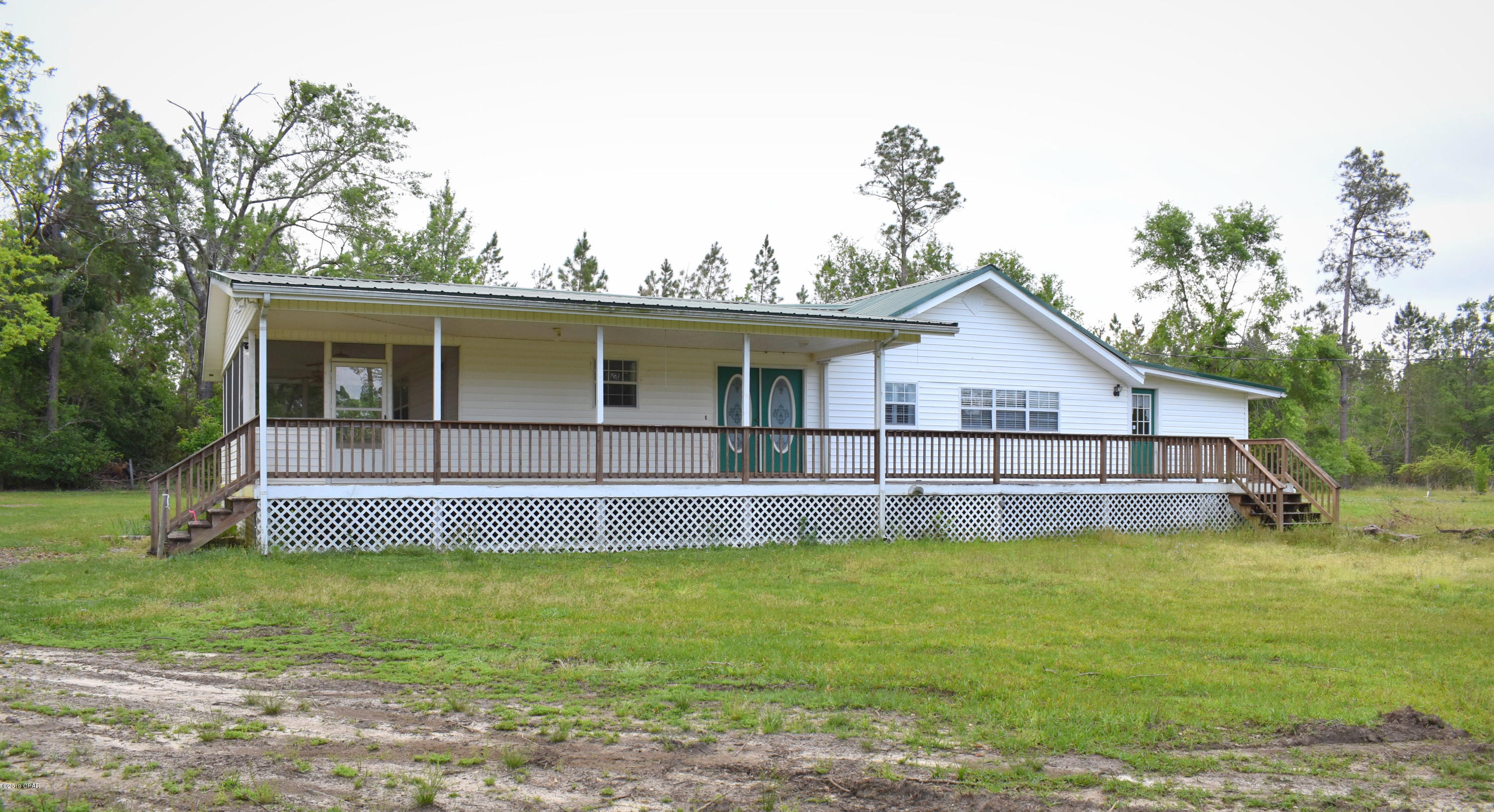 Secluded down a private drive sits this 21 acre estate, featuring 2 ponds, large storage barn, workshop, gunite pool, fencing for livestock, separate office previously used as a bakery, 2 wells and a 3 bedroom 3 bath country style home. House boast partial wrap around porch, metal roof, formal dining room, Rinnai hot water heater, 8 foot fish tank, large kitchen with island and bar top, master suite with jacuzzi tub, massive walk-in closet and sitting area. Property is located at the Washington/Jackson county line off Hwy 90.