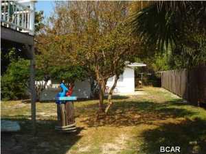 Adorable beach cottage located just down the street from the beautiful white beaches and emerald green waters of the Gulf of Mexico! This cottage is partially furnished in cozy beachy decor and has terrazo floors throughout. Nice patio area in back, out door shower too! Appliances include a full size washer, no dryer or hookup - but clothes line in place. This is an adorable cottage, enjoy the quiet serene afternoons in the secluded yard, take a stroll down to the lovely beaches. Rent includes water, trash service and lawn maintenance. Sorry NO PETS....