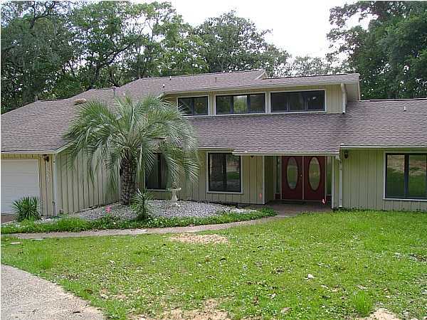 WATERFRONT!  This awesome home has sunken living room, fireplace, wet bar, 2 offices, large balcony, den, playhouse, sprinkler system, dock, storage shed, 2-car garage, and more!