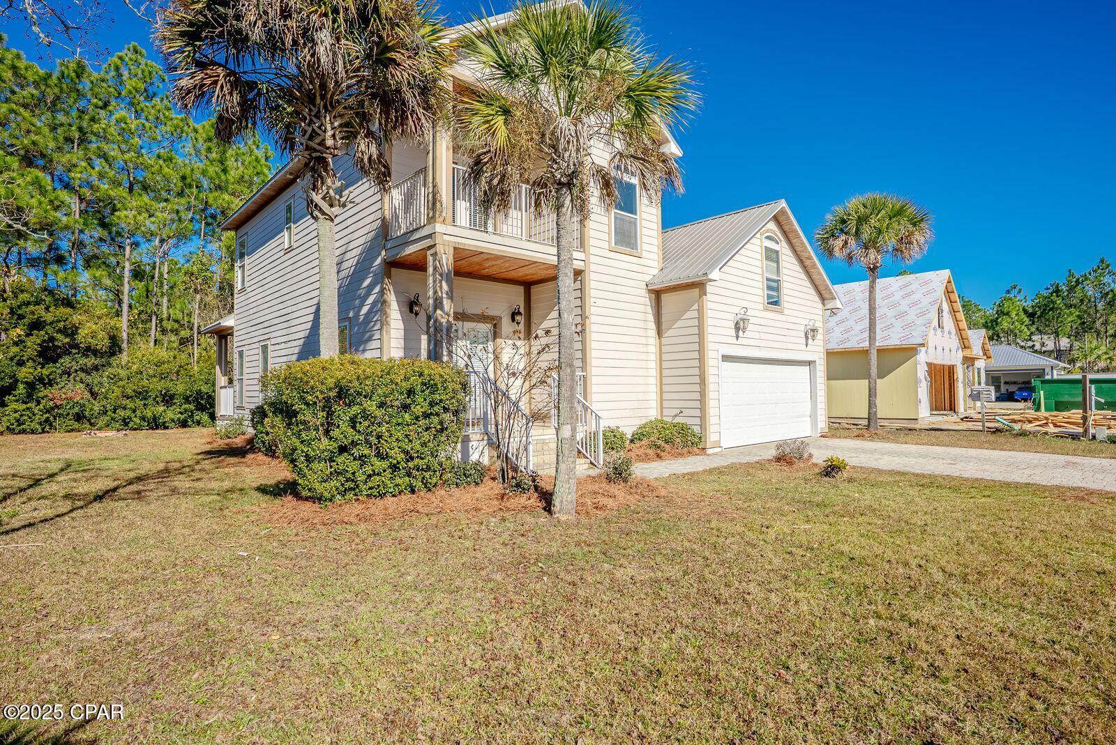 Location! Location! Location!  Price Reduced!!   This home is located only minutes from San Destin, white sandy beaches, and 30A.  From the West end of Panama City Beach, you are only 20 minutes away and 30 minutes from the International Airport. This Beautiful 4 BR 2.5 BA sits  on a spacious lot with no HOA. It is a small Subdivision with a Cul De Sac. Next door is a million dollar  custom home being built.   Enter the French doors to the family room with fireplace & into the dining area which is  open to the kitchen, thus seating 4 at the breakfast bar.  Custom crown molding throughout the home and tiled flooring through out except for 2 bedrooms. There is a large pantry & custom cabinets, stainless steel appliances, granite counter tops, and additional storage. This great open floor plan flow circles you back into the family room, half-bath, master bedroom on the first floor, and  laundry room..The 1st floor primary bedroom has custom walk-in closet, en suite bath, separate shower & Jacuzzi tub,  10Ft ceilings make this home feel open and expansive.  Upstairs offers 2 oversized bedrooms, 1 with attached balcony. Additional bedroom could be an office, den or game room. Main level attached garage with shelving located next to the  large walk in laundry room with sink. This home has just received fresh interior paint. Land is Conservation Residential.  New Air conditioner system installed in 2024. The lot goes further back if you wish to clear more of the land.  This area is booming with new restaurants, shopping etc.   Excellent primary home, investment secondary home or vacation rental.   See Agent remarks.