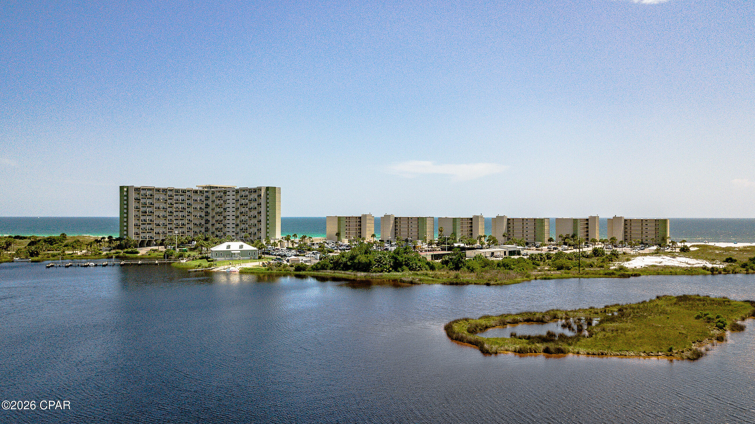 Updated Coastal Condo with Gulf & Inlet Views | Pinnacle Port | West End Panama City Beach

Located in the quiet, highly desirable west end of Pinnacle Port, this recently renovated 2-bedroom condo offers a rare combination of Gulf views, inlet (Lake Powell) views, and strong short-term rental potential in a gated beachfront community.

Positioned in the tower, this unit captures expansive views of the Gulf of Mexico and Lake Powell, providing both sunrise and sunset scenery from the private balcony. The elevated location allows for abundant natural light and a more private, peaceful setting compared to lower-level units.

The interior features a recently updated, open-concept layout designed for functionality and coastal living. The kitchen includes modern finishes, updated appliances, and ample cabinet storage, flowing directly into the living and dining areas--ideal for entertaining or maximizing rental appeal. Both bedrooms offer updated finishes and comfortable accommodations suited for full-time living, second home use, or vacation rental guests.

Pinnacle Port is known for its low-density beachfront setting and direct access to both the Gulf of Mexico and Lake Powell, one of the area's most unique features for water activities. Community amenities include two swimming pools, direct beach access, tennis and pickleball courts, fitness center, boat ramp, and 24-hour gated security.

This location offers a quiet coastal environment while remaining within close proximity to 30A, shopping, dining, and area attractions, making it highly attractive for both investors and buyers seeking a beachfront condo on Panama City Beach.

Ideal for a primary residence, second home, or income-producing short-term rental property, this unit combines updated interiors, dual water views, and a sought-after west end location.

All measurements are approximate and should be verified by buyer.