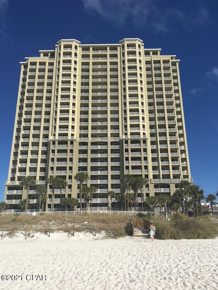 Grand Panama Beach Resort one of the most desired Resorts on the Beach. Beach front with a great view. 2 bed 2 bath w/bunks. This condo looks brand new. Newer furniture, Hardwood floors and tile throughout. Large Balcony overlooking the pool and beautiful Gulf of Mexico. 2 pools, tiki huts, fitness facility , business center, event center, and more. 2 head boards and 2 balcony chairs not included in sale. 

Call or text broker Woody Junot for showing instructions 972-415-2502