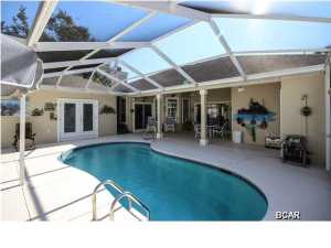 you can not enjoy the beauty of this home until you take a tour of the home...very open floor pan..split bedrooms...family room with fireplace,breakfast area,kitchen with large breakfast bar, living room ,dinning room, two master suites and two master baths, additional full bath ,1/2 bath outside for pool area, enclosed screened pool, with lots of space for entertaining and cook outs, from the pool area you will see a rock garden with flowing water....please come tour me because i am so beautiful!!!!!!!!!! come join the Bay Point community of golf,security gates,clubs,restaurants, salons, beach area, walking and bicycle paths, and last but not least the marina