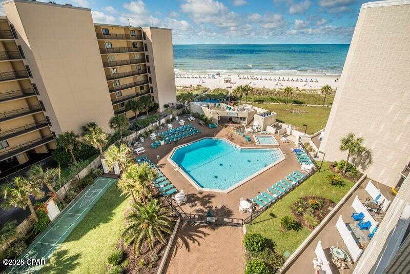 Updated ground-floor studio condo at Top of the Gulf with a private patio! Guests and owners alike will appreciate the convenience of walk-out access to the Gulf-front pool, sugar-white sand beaches, and resort amenities, no elevators required. As an added bonus, you're just a short stroll along the beach to the newly opened Tootsie's entertainment complex, where live music, dining, and nightlife add even more excitement to the coastal lifestyle. This condo offers an exceptional blend of modern coastal style and short-term rental opportunity,  Beautifully renovated, the condo showcases a fresh, contemporary interior with upgraded tile flooring, granite countertops in both the kitchen and bath, high-end soft-close cabinetry, a custom tiled walk-in shower, designer fixtures, updated furnishings, and a cozy fireplace feature that elevates the guest experience. Major system improvements include an updated HVAC system, hot water heater, appliances, and an enhanced owner's storage closet, creating a true move-in or rent-ready opportunity. One of the most desirable features of this residence is its rare ground-floor location with a private patio, exclusive to ground-floor units. Enjoy the convenience of stepping directly outside to your own garden-style outdoor space, ideal for morning coffee, relaxing after a beach day, or accommodating pet-friendly owner use in accordance with association rules. Guests and owners alike will appreciate the easy walk-out access to the Gulf-front pool, sugar-white sand beaches, and resort amenities without ever needing to use an elevator. Whether you are seeking a vacation rental, a personal beachfront retreat, or a low-maintenance investment property, this condo delivers exceptional versatility and value. Top of the Gulf offers an array of amenities including a Gulf-front pool, game room, BBQ and picnic areas, beach showers, snack bar, owners' lounge, and on-site management, all within one of Panama City Beach's most recognizable beachfront destinations on Thomas Drive.