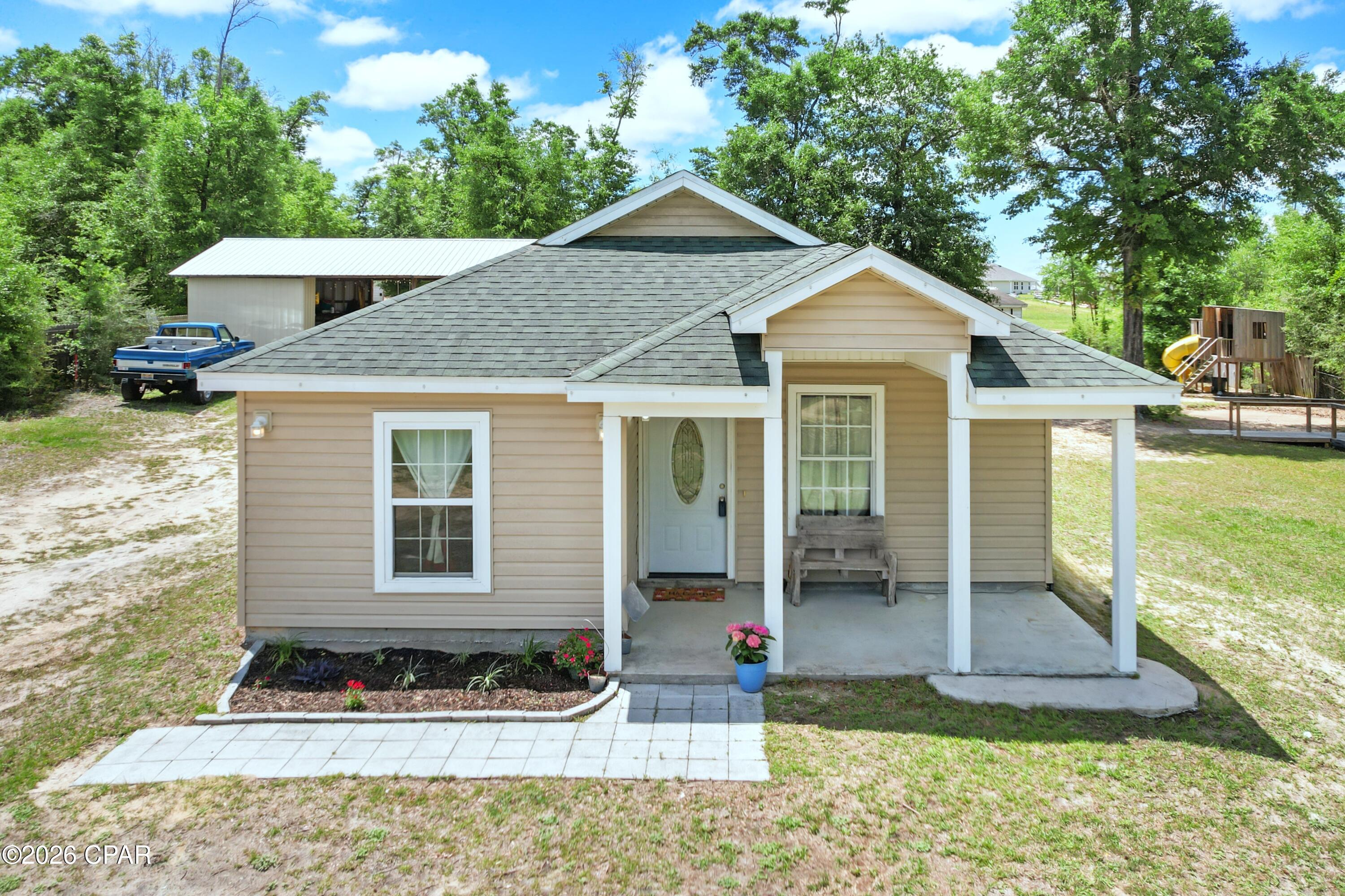 HOUSE + ACRE PARCEL + POND + POLE BARN!!  This 4 bedroom, 2 bath home sits on an acre of land with a fishing pond and a 24x36 pole barn.  Inside, you will find an open floorplan with vinyl plank flooring in the main living areas, carpet in the bedrooms, and tile flooring in the bathrooms. The kitchen features ample counter space, a breakfast bar, a pantry, stainless steel appliances, and it opens to the dining area which flows into the living room. The vaulted ceiling gives the home an open feel and the decorative shelf along the top wall is ready for your personal decor. The interior laundry room is conveniently located between the bedrooms, and there is an 11x8 pantry/utility room for added storage and convenience.  The spacious master suite features an adjoining bath with an extra-large double sink vanity, a walk-in closet, and a shower/tub combo with stylish tiled walls. The additional bedrooms provide comfortable space for family, guests or home office. Step outside and enjoy the peaceful setting from the rocking chair style front porch or relax on the back patio with the covered shade sail that conveys with the home. The pond has bream and bass, making it a great spot for fishing right in your own backyard. NOTE: The pond level depends on the rain.  BONUS: The adjoining cleared back acre parcel can be purchased separately if additional space is desired. Located a little over 3 miles from Cherokee Boat Landing, you can launch your boat into Deer Point Lake for a day on the water. Call today to preview.  Measurements approximate.