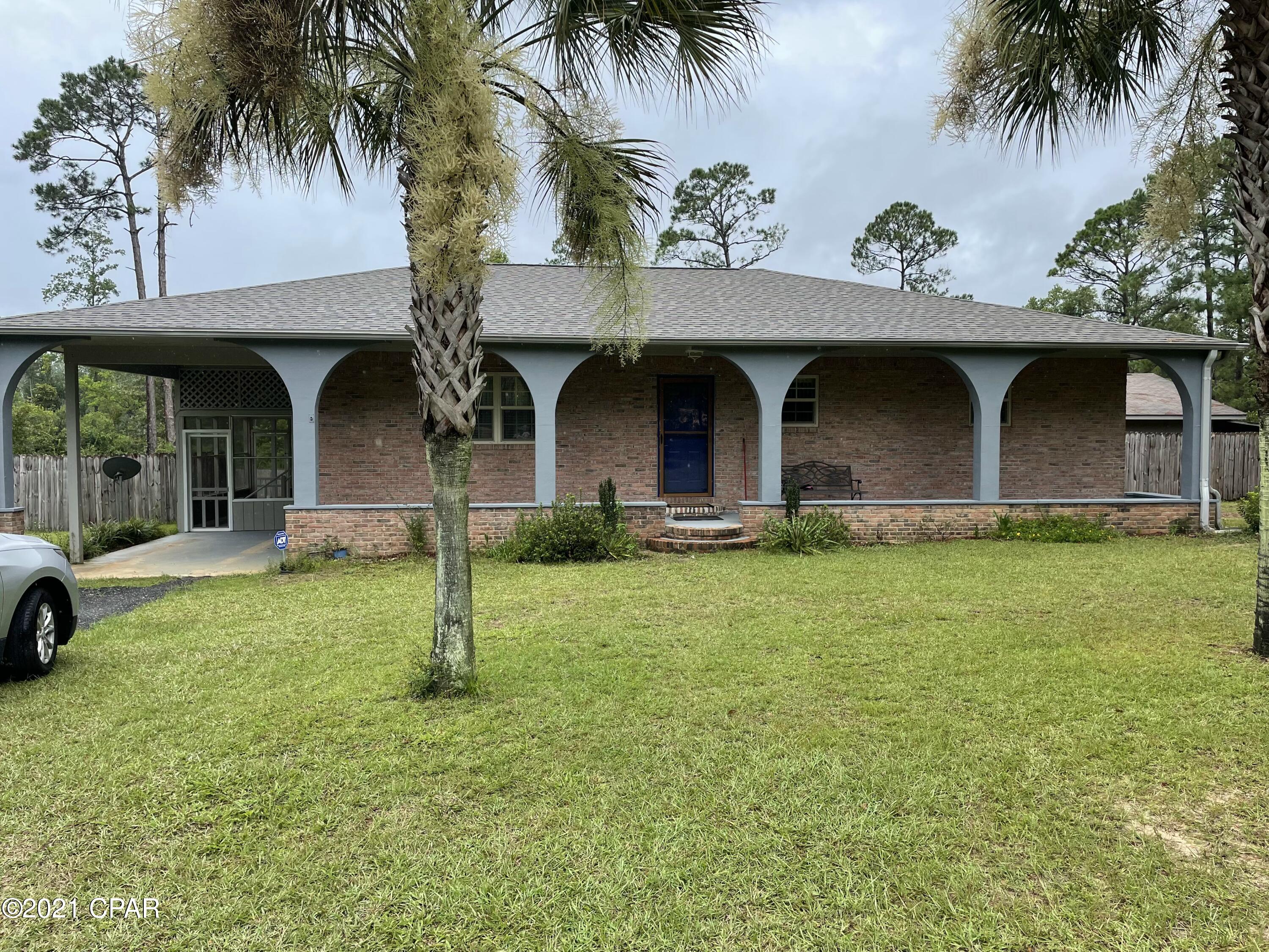 Nice home on 1.2 acres! This 3/2 home has a large living room and a large kitchen/dining area.  Kitchen comes with a gas stove and large pantry.  New roof in 2019.  Outside wood of the home was recently painted.  The highlight of this home is the large back yard that is completely privacy fenced and includes a large workshop/garage.  Yard has several chestnut trees, grape vines and figs!  There is a very nice screened in back porch with storage underneath and a screened porch on the side of the home by the carport.  Home is located in the Compass Lake in the Hills Subdivision is right off of Fairview Rd. for easy access to Marianna and Panama City.  Make an appointment today!