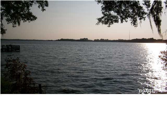 Georgeous Waterfront lot on Deerpoint Lake with over 1.28 acres. This long held family land is now available and offer 146 feet of deepwater frontage with unobstructed lakeview, no marsh, no muck. Convenient location just off Highpoint Road. Paved County road turns into private road This is a high and dry lot with high elevation, a seawall, and according to the owner has never flooded. Large pretty oak and magnolia trees and good neighbors help make this a perfect lot to build your dream home on. The lot has a capped well on it. Underground electric and restrictive covenants help make this appealing as a perfect lakefront homesite. A deep well and septic tank are required. Fish, boat, and swim in your backyard and watch unobstructed sunsets 365-days a year. All things considered, this is probablly the finest lot for sale on Deer Point Lake