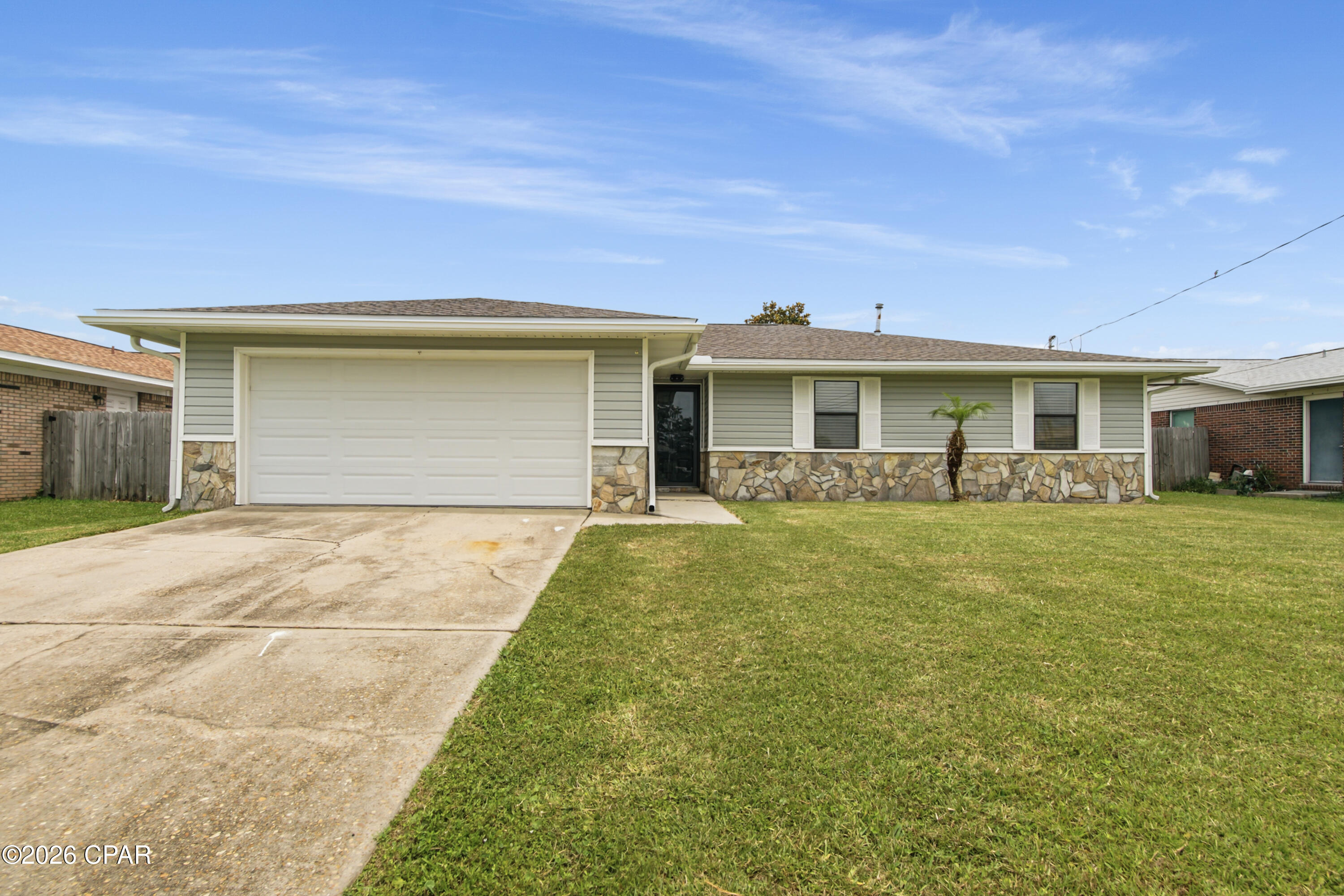 Welcome home to this beautifully renovated 3-bedroom, 2-bathroom property featuring a spacious double attached garage and an impressive 28' x 13' sunroom overlooking the large, fenced backyard. Recent updates and improvements make this home move-in ready, offering the perfect blend of comfort, functionality, and value. Enjoy a family-friendly neighborhood with no through traffic, perfect for kids to ride bikes and for morning walks to enjoy the sunrise over East Bay! Perfect for a growing family or someone who enjoys a little extra privacy without having to be in a rural area with fewer amenities and job opportunities.  

Pull up to this beautifully refinished home and walk in through the front door, step inside to find a refreshing, well cared for home with light, classic colors from the brand new luxury vinyl plank throughout, to the fresh paint, and so much more. Every detail has been considered to make this home ready for new owners. To the left, you will find the living room. A fireplace enhances the room's elegance, along with plenty of natural light from the private side and back yard. Off the living area is a dining space large enough for a growing family and dinner guests. From here, you can step into the breakfast nook and kitchen with all-new appliances. The laundry room is just off the kitchen. Step back into the living room, which also leads to the back door, where you will step into a very large sunroom, perfect for cozy coffee in the morning or for hiding from the sun as you watch over the very large backyard, fully fenced in, that offers lots of privacy and plenty of space for your future pool and workshop plans. Back inside and down the hall, you will find a bathroom, two sizable bedrooms, and a well-lit, very large primary bedroom with a walk-in closet and a full primary bathroom, all completely remodeled. The oversized garage is to the left of the front door and has plenty of shelving for all your storage and project needs, as well as a very convenient side door to access the fenced-in side yard with a gate. 
Close to Tyndall Air Force Base and just 20 miles from Panama City Beach and Mexico Beach, this location offers a small-town feel with day-trip amenities nearby. The home is in a well-maintained neighborhood with no HOA or flood insurance required. Enjoy easy access to parks, shopping, dining, and daily needs--ideal for families, professionals, or anyone seeking a relaxed Florida lifestyle.
