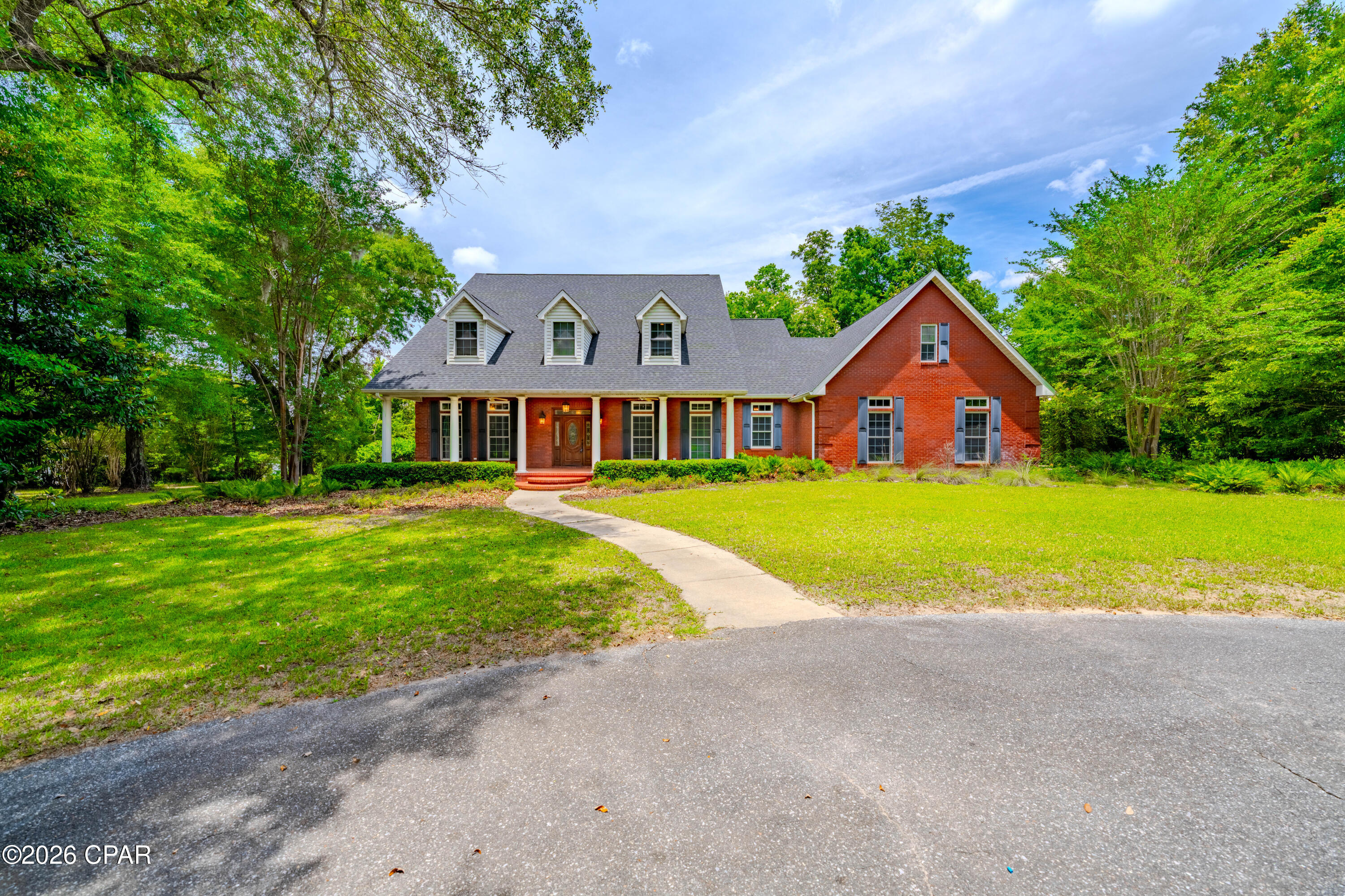 Welcome to this exceptional custom-built estate, perfectly positioned on what may be the most beautiful and private 4-acre homesite on Merritt's Mill Pond. Immaculately maintained and thoughtfully designed, this stunning waterfront property offers the perfect blend of luxury, comfort, and outdoor living.  Located only a half mile from 18 holes of golf at the Indian Springs Golf Course.  

Follow the gently rolling landscape down to your private dock, where crystal-clear, spring-fed waters invite you to spend your days fishing, kayaking, boating, swimming, or simply enjoying the breathtaking natural beauty that makes Merritt's Mill Pond one of Florida's hidden treasures.

Inside, this spacious 5-bedroom, 3.5-bath home with a dedicated office showcases quality craftsmanship and timeless design throughout. Elegant details such as coffered ceilings, crown molding, and custom built-in bookcases create a warm and refined atmosphere. The chef's kitchen is designed for both everyday living and entertaining, featuring a large center island, pantry, double ovens, gas cooktop, and stainless-steel appliances.

The generously sized first-floor primary suite offers a peaceful retreat with a luxurious en-suite bath and abundant closet space. A desirable split-bedroom floor plan places the additional four bedrooms upstairs, providing privacy and flexibility for family and guests. The open-concept living areas flow seamlessly throughout the home, while the dedicated office offers the perfect space for working remotely, studying, or managing daily tasks.

Step outside to enjoy the expansive covered porch, complete with a convenient gas hookup for grilling and outdoor entertaining. Overlooking lush green lawns that has its own underground irrigation system, this outdoor living space is ideal for relaxing with family and friends year-round.

Additional features include an attached two-car garage, ample driveway parking, and a setting that offers both privacy and convenience.

Rarely does an opportunity arise to own such a pristine waterfront estate on the crystal-clear, spring-fed waters of Merritt's Mill Pond. Schedule your private showing today and experience this extraordinary property for yourself.