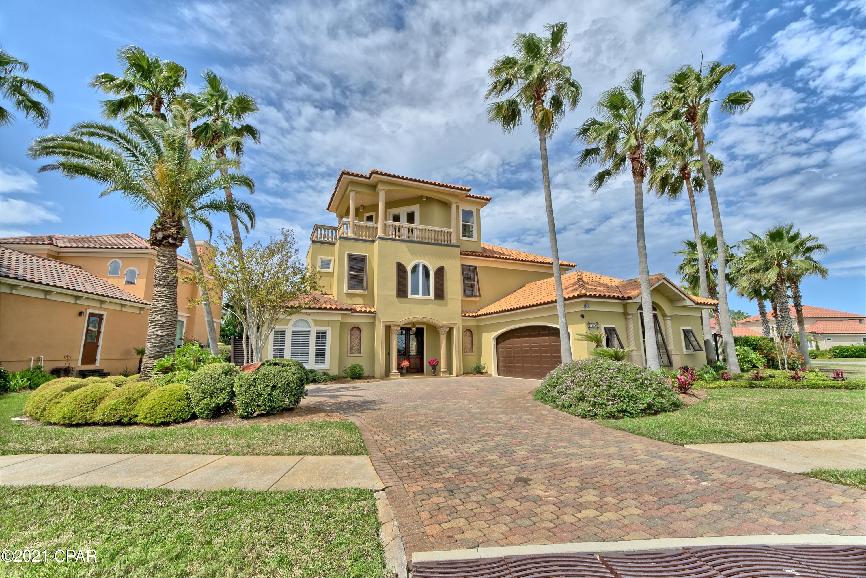 CURRENTLY UNDER CONTRACT, SELLER ACCEPTING BACKUP OFFERS Beautiful Mediterranean home located on two lots in the exclusive gated community of Finisterre! Located on the east end of Panama City Beach, this home features 4 bedrooms, 2.5 bathrooms, a bonus room and 3rd floor entertaining room with views of Grand Lagoon. The family room and kitchen offer a open floor plan with high ceilings and lots of windows for natural light. The oversized master suite is located on the first floor with a sitting area and large walk-in closet. The master bath offers double vanities, a jetted tub and separate shower. The remaining 3 bedrooms and bonus room are on the 2nd floor of the home and have a shared bathroom with a double vanity. The 3rd floor has a built in bar with a wine refrigerator, beautiful bui