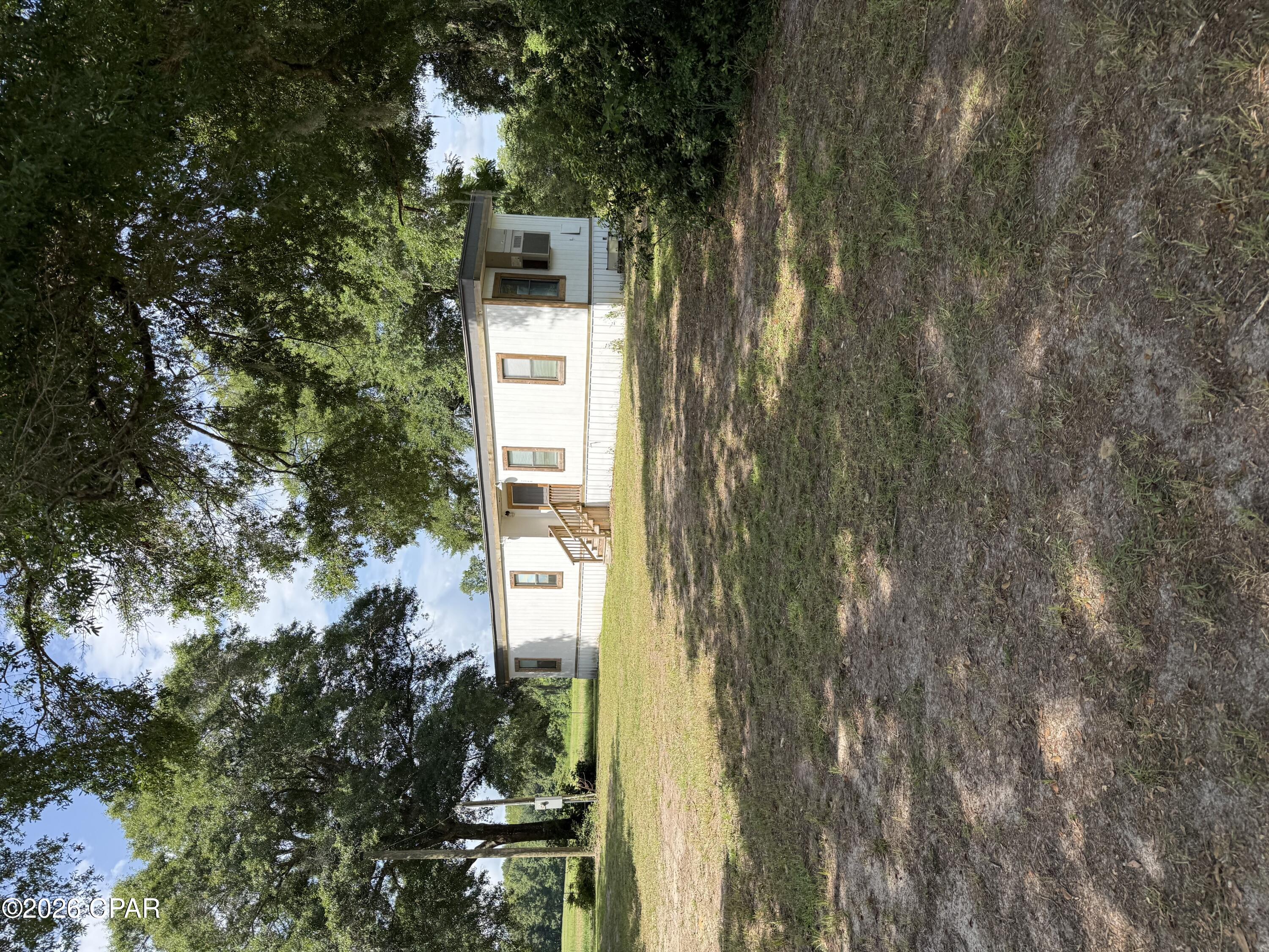 Two move-in ready small homes (mobile home and apartment style tiny home) on 2.11 acres! - 
The first home is an older model 1 bed/1bath, 664 sq. ft. single wide that has been renovated and updated with a rustic finishes, hard wood floors, wooden counter tops, and a wooden accent wall in the living room. The home is cooled with a single AC unit. Washer and dryer convey. 

The 2024 1 bedroom/ 1 bath tiny home/apartment (approx. 496 sq. ft.) sits directly behind the first mobile home behind a buffered tree/shrub line for privacy and  is cooled/heated with a single window unit. It has one main bedroom and two lofts for extra sleeping space as needed. It is also trimmed in rustic finishes. Washer and dryer convey. Both homes share a well but have their own septic tank.

The property has a fenced off area on the left side (approx. .86 acre pasture), with water if you would like to bring your horses or other livestock. 

These homes would be great rentals, primary residences for a multiple family situation, or even short term rentals for river enthusiasts, wildlife management hunters, and Florida natural springs explorers. 

Survey available! Cash buyers only. No owner financing.