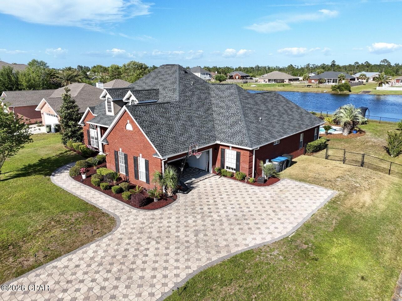 Reduced!  Don't miss out on this exclusive Waterfront Pool Home with an Assumable 3.65% FHA Loan for qualified buyers!  Situated on over half an acre directly on the Community Lake.  This beautifully maintained custom 2649 sq. ft  all-brick home offers 4 bedrooms, 3.5 bathrooms, bonus/flex room (or office), formal dinning room, informal breakfast room, large kitchen, and a back yard designed for enjoyment of your salt water pool, and  Florida living year round.  Located in the desirable Kirkland Manor and not in a flood zone.  This property presents a rare opportunity in today's market.  The open floor plan features granite counter tops, custom frame windows, crown molding, abundance of natural lighting and surround system throughout the the interior and exterior of home.  The kitchen offers stainless steel appliances, a center island, large breakfast bar, walk-in pantry and extensive cabinetry, thus making it ideal for everyday living and entertaining with the open floor plan.  Two additional bedrooms share a Jack and Jill bathroom.  New roof installed in 2024, HVAC installed in 2025, two new water heaters installed in 2025, new pool pump in 2024, microwave/dishwasher both installed in 2024.   Step outside to your own Lake waterfront retreat featuring a saltwater pool with upgraded sand filtration, a 5 person hot tub, expansive brick paved patio, covered porch, professional landscaping, sprinkler system, and a fully fenced backyard overlooking the lake. Enjoy fishing kayaking and paddle boarding right from your backyard.  Deerpoint Lake is minutes away  with a public boat ramp.   Conventionally located and move-in-ready custom home offers the perfect combination of waterfront living, modern and upscale updates, and outdoor enjoyment.  This is a fabulous opportunity  to own a waterfront pool home with and assumable and rare 
3. 65% FHA Loan.  Schedule your showing today!
