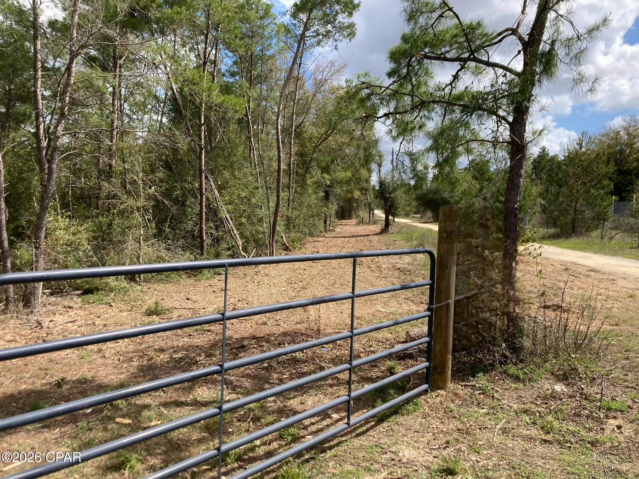 Looking for country living not far from the beach just outside of Bay County? This parcel is a great place to build a home or a weekend get a way. This 8.55 acre property has a new private drive that has just been cleared and has plenty of room to build a home and shop. It is only 45 minutes from the beautiful white sand beaches of Panama City Beach. The parcel also has over 600 ft. of Hwy. 77 road frontage and previously had a mobile home on it years ago and it has a well, septic and electricity available.
All measurements and items of importance are to be confirmed by buyer or buyer agent.