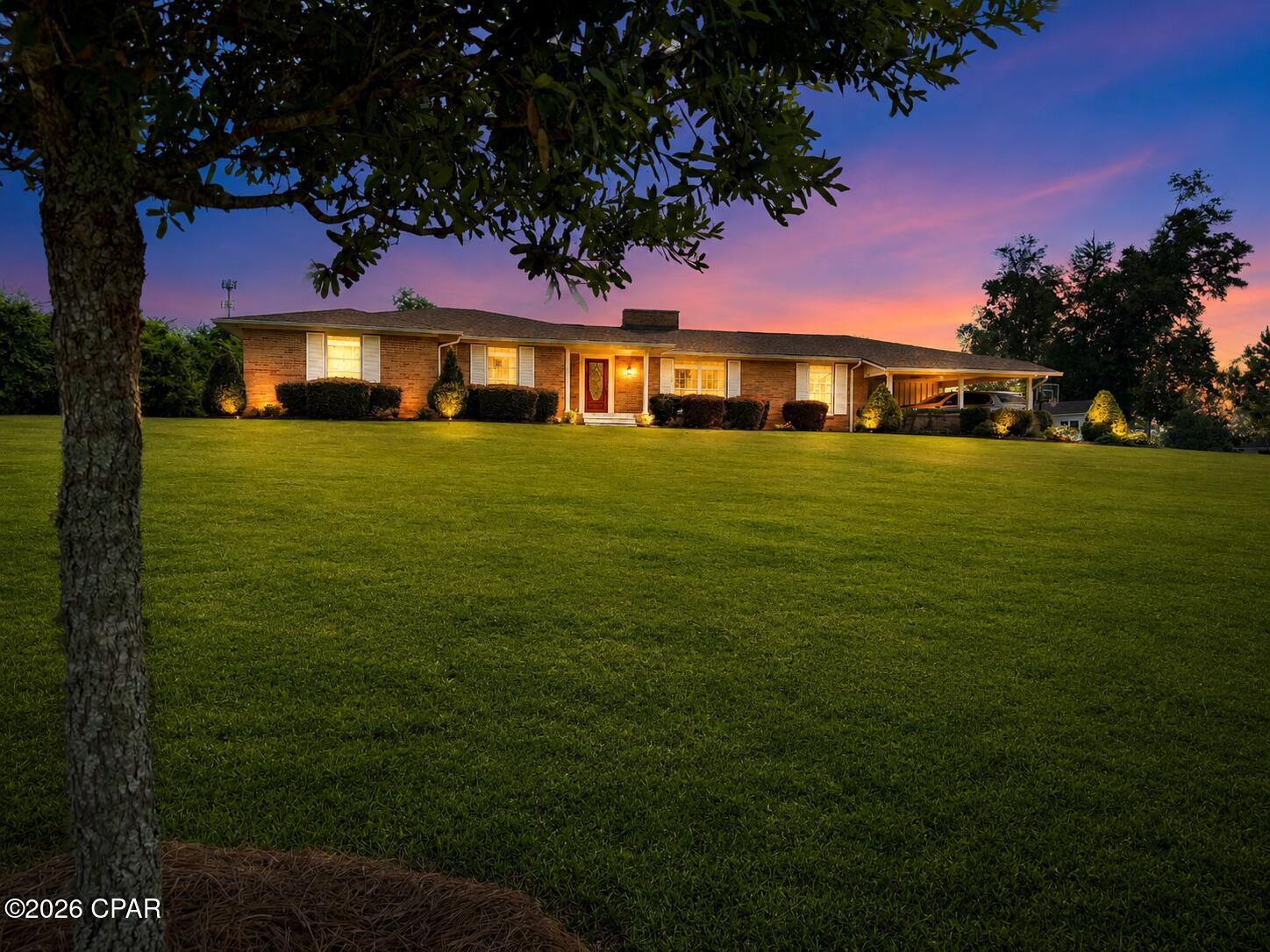 Completely rebuilt from the ground up, this stunning 4-bedroom, 2.5-bath home offers the perfect blend of modern design, functional living, and an unbeatable location in the heart of Marianna, Florida. Situated on a beautifully landscaped 1.13-acre lot, this property provides the space you've been searching for while keeping you close to everything downtown has to offer.

Step inside to discover an open-concept floor plan featuring gorgeous wood flooring, abundant natural light, and designer finishes throughout. The heart of the home is the custom chef's kitchen, thoughtfully designed with beautiful cabinetry, quality finishes, and plenty of space for gathering with family and friends.

The spacious family room is highlighted by a unique white-painted brick fireplace, soaring vaulted ceilings, and sliding glass doors that open to the fully fenced backyard, creating the perfect indoor-outdoor living experience. Outside, you'll find a charming brick patio overlooking the expansive yard with plenty of room for children, pets, gardening, or entertaining.

Need extra space? This home also features a dedicated home office or fitness room, providing flexibility for today's lifestyle. You'll also appreciate the beautifully designed mudroom and laundry area, complete with a convenient half bath, abundant cabinetry, and exceptional storage.

Location is everything, and this home truly has it all. Enjoy the convenience of being just a short walk to Chipola College baseball games, the public swimming pool, and the Chipola Regional Arts Center, where you can experience local theater productions and community events.

With modern finishes, spacious living areas, exceptional storage, beautiful landscaping, and a prime in-town location on large lot, this one-of-a-kind property offers the perfect place to call home. Don't miss your opportunity to own this beautifully reimagined Marianna gem!