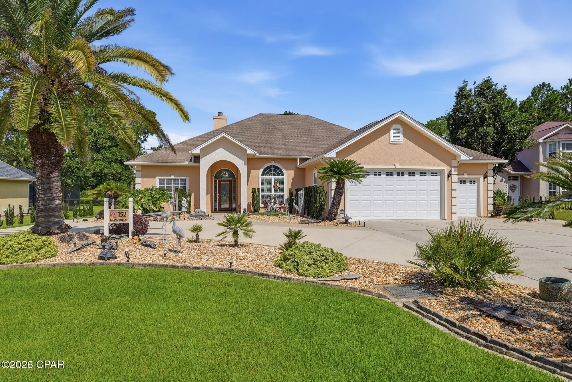 Custom Construction in THE GLADES, Panama City Beach, Florida...Welcome to 152 Grand Heron Drive, an exceptional, custom-built residence which departs from the mass-produced, offering craftsmanship and architectural detail designed for secure and tranquil living, all with a large pool, Sundance Spa, idyllic water views -- AND all on ONE LEVEL. This COMFORTABLE home with its split bedroom floor plan showcases OPENNESS as soon as you enter the handsomely landscaped, large CIRCLE driveway. Step inside the beautiful leaded pattern-glass door and observe neutral porcelain tile throughout the home, a flowing floor plan that displays the elegance of 12' ceilings, crown molding, 2x6 construction, deep PLANTATION SHUTTERS, arched openings, and LOTS of LIGHT! HVAC is a 2023 Trane 4-ton and Trane 5-ton heater which is enough energy to heat and cool this large high ceiling home.  SOLAR PANELS accommodate half if not all the electrical cost. The Panels are on a Wi-Fi program aligned with internet that shows if any panel is not producing.                         
A new wind mitigation report showing hurricane improvements has led to significant insurance savings with a new insurance company. All standard exterior doors, French doors, garage doors, and windows are hurricane rated, are tinted, and are very durable...never have to be painted. The acrylic block bathroom windows all have hurricane rated panels that are easy to put up, and the beautiful stained glass and wood front door has hurricane rated fabric that is also easy to install. All outside doors have Schlage locks with key and keypad access. The security system SimpliSafe is a break into home alert system which also has smoke detectors and water sensors under sinks and hot water tank, all with 24-hour monitoring. The MAIN LIVING area includes a FIREPLACE updated with a Dimplex electric insert and lighted, built-in glass display shelves and storage cabinets on both sides; note the four large windows with pool views. The GENEROUS formal dining space accommodates seating for 12 and transitions seamlessly into the living area. The PRIMARY suite showcases French-door access and views of the pool and spa area and includes seating area, two walk in closets, a large light-filled bathroom with separate vanities, and both a tub and spacious shower. Don't need a fourth bedroom? A generous area includes a LARGE, flexible-use room that might serve as an OFFICE for TWO &/or an area for hobbyist. The KITCHEN has BEAUTIFUL CABINETRY, built-in oven & microwave, refrigerator, and an ISLAND that includes a PREP SINK. The space flows into a breakfast area then into the FAMILY ROOM with easy access to the pool deck. The laundry area is large with lots of countertops and cabinet space, storage closets, and extra full-size refrigerator.  Now out to the LARGE, screen-enclosed pool accessible from three points in the home. The pool has Hayward equipment, and with its copper granules, chlorine use is minimal. The pool deck is laid with true TRAVERTINE stone pavers. The November 2025-installed screen POOL ENCLOSURE with ''Clearview'' end screen enhances picturesque pond views, meets city code requirement of up to 140 mile an hour wind, and has the latest 17/20 polyester screen.  Rain gutters & a sprinkler system that includes adjustable bubblers are in place. The GARAGE has spaces for VEHICLES, golf cart, &/or work tables and equipment; pull-down stairs leads to floored storage above. This home & beautiful community with its LOW fees which includes trash pick up are within minutes of the Sugar Shore and Emerald Waters with three major access points, two at lighted intersections for safety and convenience. Shopping, fine & casual dining, entertainment, & medical facilities including a NEW branch of Tallahassee Memorial, are minutes away. Schools are nearby...Gulf Coast College & a branch of FSU. DUPLIN Winery & its LIVE MUSIC and beautiful gift shop is just a golf cart ride away. Come join the FUN!
