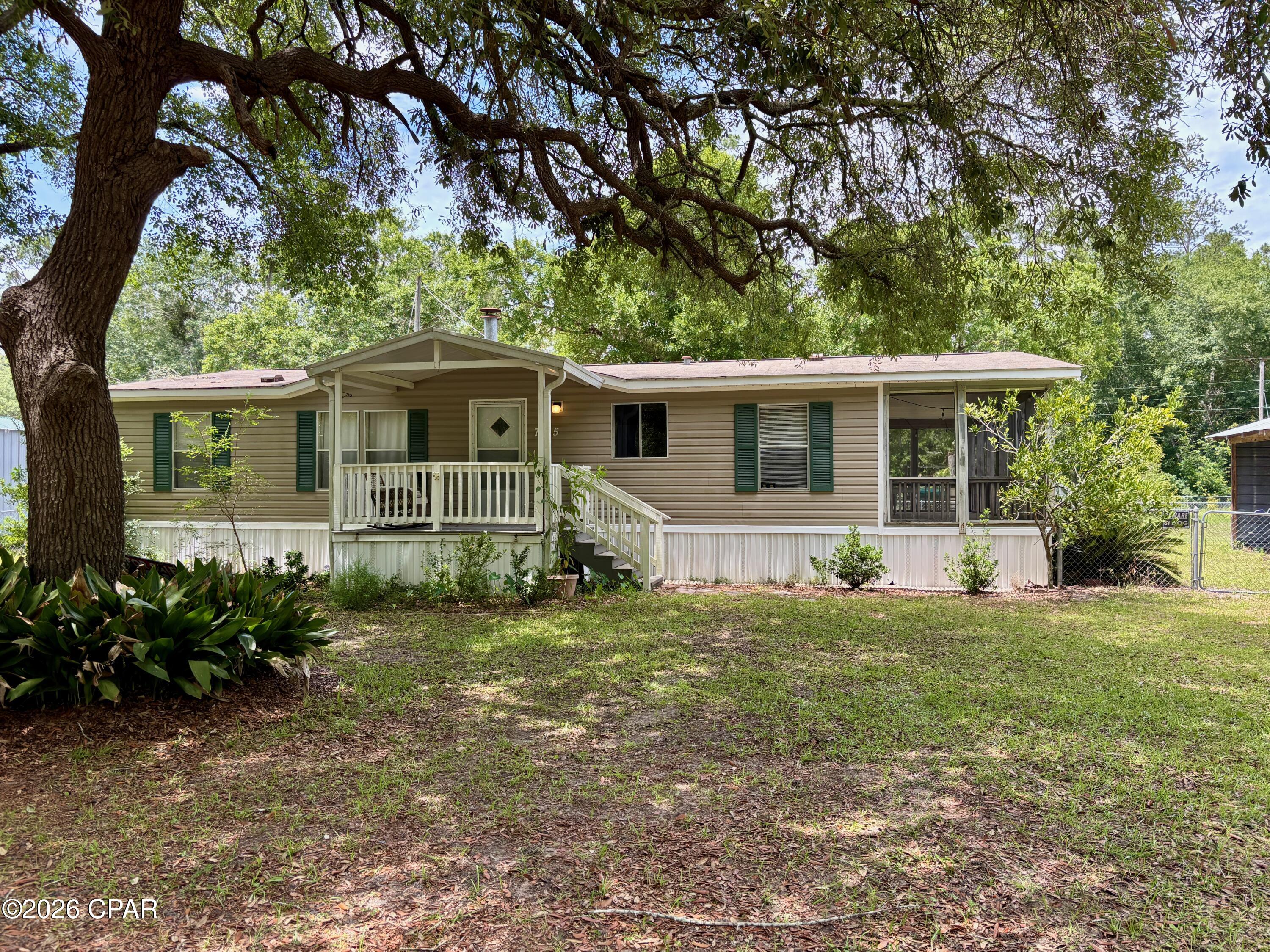 Welcome to your perfect Howard Creek getaway or forever home! This beautifully maintained, fully furnished 3-bedroom, 2-bathroom home sits on a generous lot designed for the ultimate Florida Panhandle lifestyle. Inside, relax by the cozy fireplace in the spacious living room, cook in the seamless eat-in kitchen, or catch up on remote work at the built-in desk. Every bedroom features its own walk-in closet, and the primary suite boasts a spacious en suite with a standalone shower. Host the ultimate fish fry in your outdoor kitchen, complete with a convenient half bath and extra storage. The additional outdoor setup features a large covered carport with an attached storage room within the fully fenced yard and a second double carport with dedicated space for your river boat, golf cart, and beach gear. From the screened porch to the unmatched storage for all your watercraft, this home is fully equipped to help you live the Howard Creek lifestyle from day one.