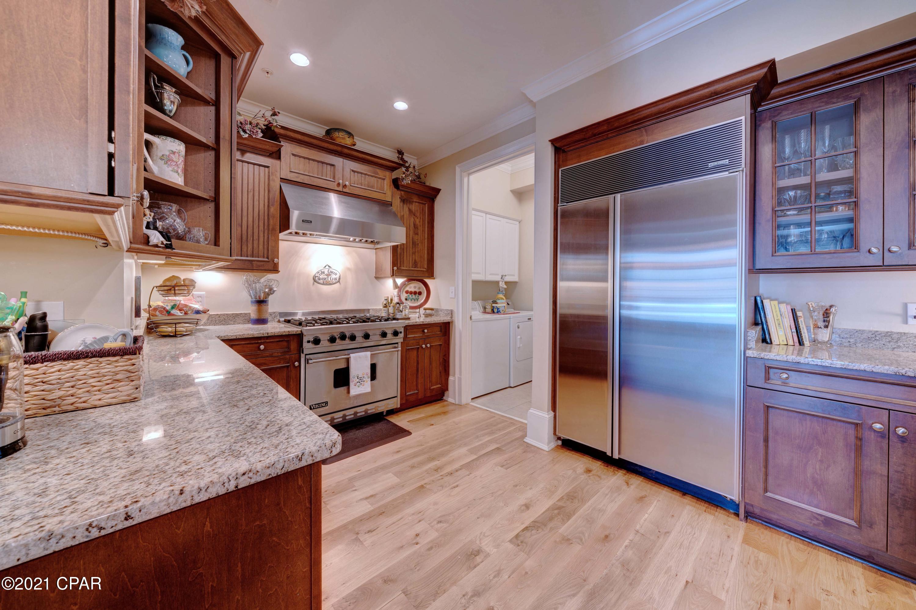 UNDER CONTRACT...SELLER TAKING BACKUPS!!! Welcome to Waterhaven! Beautiful bay front residential community with a seasonally heated pool and no rentals. This ground floor unit makes entry and exit a breeze from your covered front porch or back parking space. This unit boasts 3 bedrooms and 2.5 bathrooms, an upscale kitchen with granite counters, custom cabinets, Sub Zero refrigerator, brand new wine refrigerator, new Scotsman ice maker, Viking six burner gas range, Bosch dishwasher and filtered water and soap dispenser conveniently located at the kitchen sink. In addition, this unit has a new A/C, tankless water heater, and newly refinished hardwood flooring. The bathrooms have granite counters, custom cabinets, Travertine flooring in the master bath and tile in the guest bath. Needless to say this unit has been very well taken care of by its one and only owner. This complex has brand new metal roofing and new paint on all the buildings, maintains a boat ramp, boat, trailer and RV fenced storage yard, community dock, outdoor kitchen, fitness and weight room, home theater with deluxe recliner seating, clubhouse, seasonally heated pool, gas street lamps, gorgeous landscaping and a secure gated community for all of its residents. Clubhouse has a full commercial kitchen with a huge commercial ice machine for owner use. No need to leave the premises anytime one needs a cooler of ice for the boat or pool. The location is superb in that you are far enough from the main roads to enjoy the peace and tranquility of this waterfront community, but conveniently close enough to shopping and dining. A 5x10 separate storage room is located on the top floor easily accessible by the elevator. Verify measurements if important.