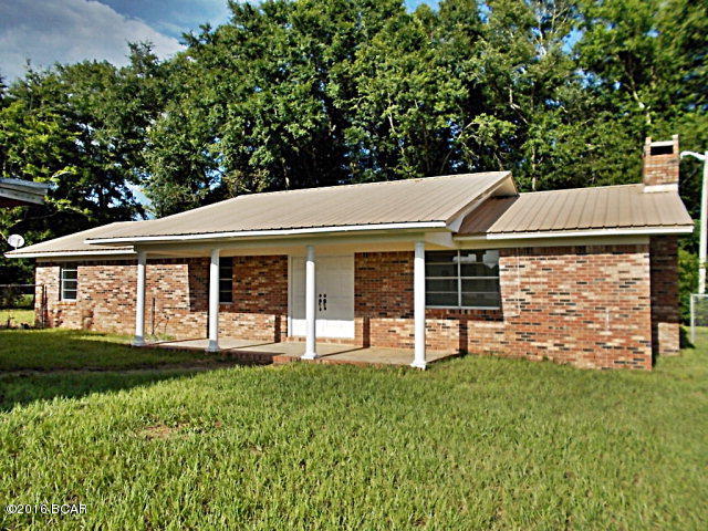 Brick home just out of town priced right, new stove, ref, dishwasher, microwave, new ceiling fans, new breaker box, newly painted throughout,new lights, tile shower, chain link fencing,metal roof this home looks and shows very good,all on a paved road, not far from town, there is an old block building on the front of the property that at one time was a liquor store, very little value left in it.