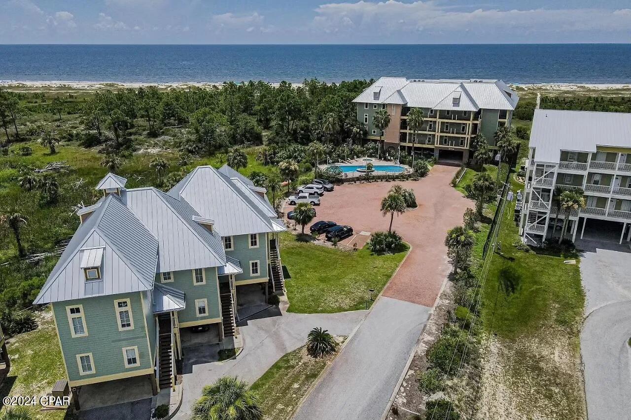 Nestled in the beachfront community of The Club at Cape San Blas, this stunning condo at 160 Cape Pointe Dr offers a luxurious coastal lifestyle. Boasting 3 bedrooms and 2.5 bathrooms, this residence is a serene retreat on Cape San Blas. Upon entering, you are greeted by an open and airy floor plan that seamlessly connects the living, dining, and kitchen areas. The living room features large windows that flood the space with natural light, creating a warm and inviting ambiance. The kitchen has granite countertops, stainless steel appliances, and ample cabinet space. The master suite is a true retreat, with a spacious layout, a walk-in closet, and an en-suite bathroom complete with a soaking tub and separate shower. The two additional bedrooms are generously sized and perfect for guests or family members. One of the highlights of this condo is its outdoor spaces. Enjoy your morning coffee as you watch the sunrise or unwind with a glass of wine as you watch the sunset from your private, screened balcony spaces. Residents and guests of The Club at Cape San Blas enjoy access to a range of amenities, including a community pool and hot tub, perfect for relaxing and soaking up the Florida sun. With a boardwalk providing direct access to the beach, you can easily spend your days swimming, sunbathing, or strolling along the pristine shores. Located on Cape San Blas, this condo offers a serene and secluded setting, yet is just a short drive away from shopping, dining, and entertainment options. Whether you're looking for a permanent residence or a vacation home, this condo at 160 Cape Pointe Dr is the perfect place to call your own.