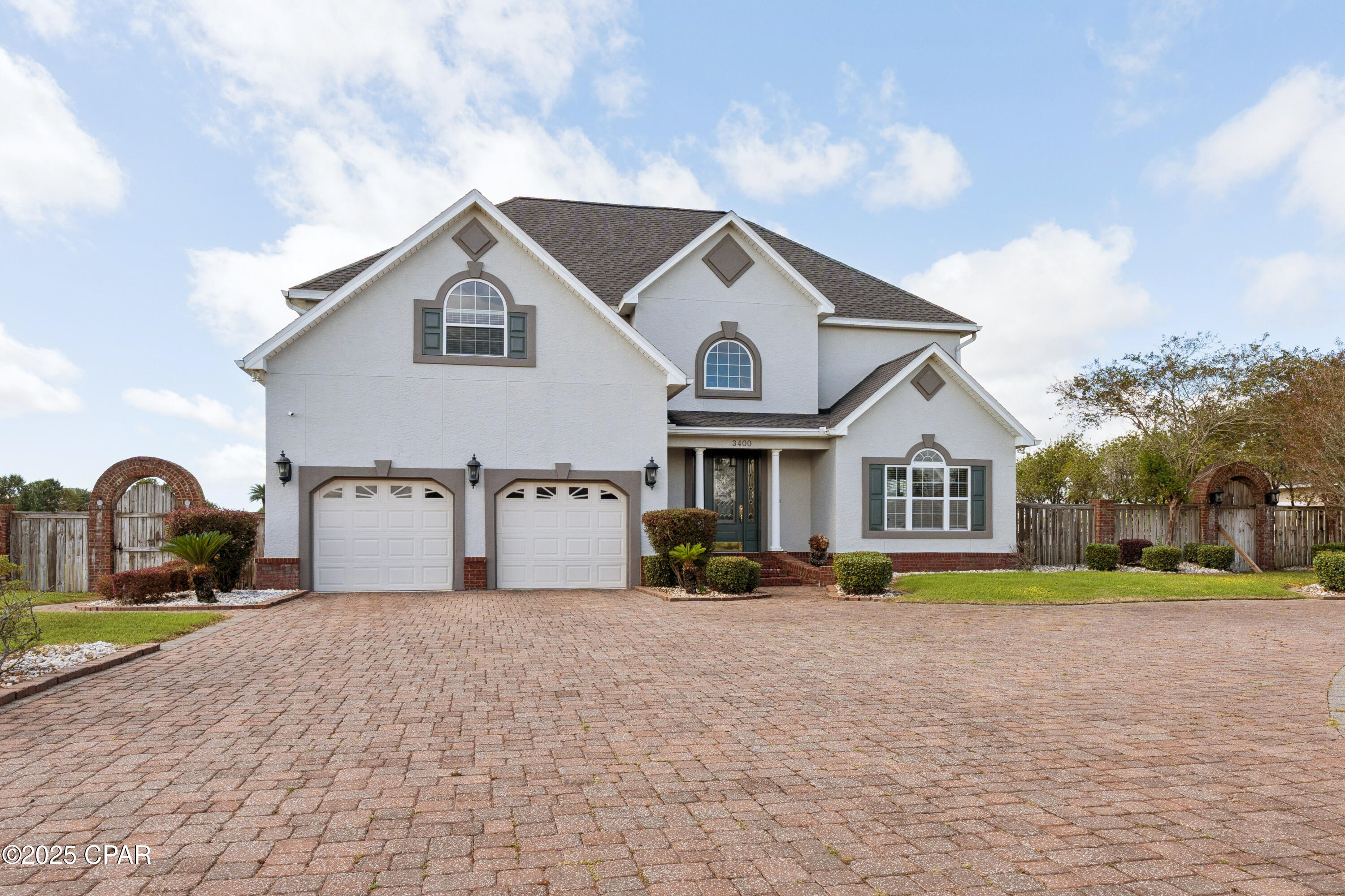 1.2 Acres • Under $800K • 10 Minutes to Lynn Haven. TWO PARCELS 07899-557-000
& 07899-558-000 This beautifully designed 5BR/3BA home sits on a peaceful spring-fed lake and offers exceptional indoor and outdoor living. The main level features formal living and dining rooms, a spacious family room with fireplace, and a custom kitchen with island, pull-out cabinetry, and abundant storage. A private guest bedroom and full bath are also located downstairs.

Upstairs, the oversized bedrooms offer generous closet space. The luxurious primary suite includes his and hers walk-in closets, a 20x10 sitting area, tray ceiling, private fireplace with built-ins, and a spa-style bath with claw-foot tub and separate shower. The second-floor family/bonus room with French doors and additional fireplace provides flexible living space.

Notable upgrades include crown molding, chair rail, decorative archways, tile flooring, multiple fireplaces, surround sound, and extensive built-ins throughout.

Outdoor living includes a screened porch, gunite pool, gazebo, and direct access to the lake for fishing, jet skiing, and water sports—all from your own backyard.