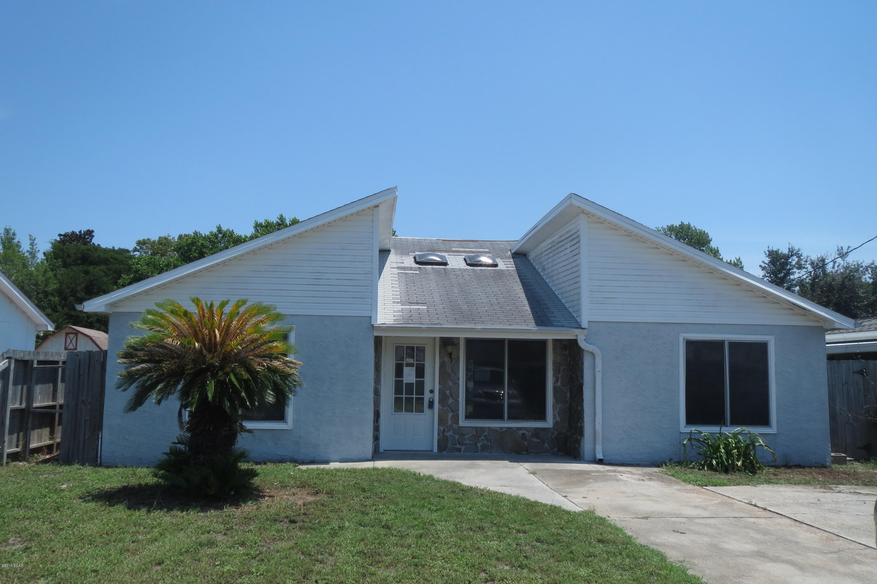 ATTRACTIVE HOME IN THE DESIRABLE OPEN SANDS SUBDIVISION!  Located within walking distance to the Gulf, this home features a spacious living room with vaulted ceilings, a large kitchen with an eat-in dining area and French doors to the open patio from both the living and dining areas.  Home is being sold in its AS IS condition.