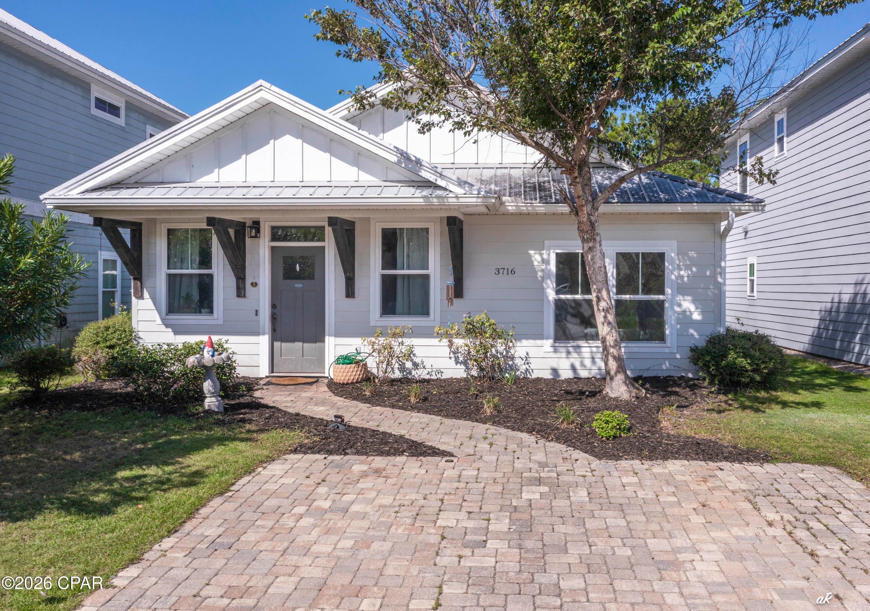 YOUR SLICE OF PARADISE AWAITS! Welcome to 3716 Tiki Drive, a beautifully upgraded Florida cottage with Rosemary Beach-inspired charm, modern finishes, and an unbeatable Panama City Beach location. Just minutes from the beach, local restaurants, and popular destinations like Captain Anderson's, Schooners, and The Grand Marlin. Step inside to a bright and inviting open floor plan featuring 9-foot ceilings, wood-look tile, and a stunning kitchen with white cabinetry, granite countertops, and stainless-steel appliances. The split-bedroom layout offers privacy, while the spacious primary suite features an upgraded tray ceiling and beautiful natural light. Outside, enjoy room for entertaining, relaxing, or letting the pets play, along with access to the community pool, perfect for cooling off and enjoying the Florida sunshine. Whether you're searching for a full-time home, beach getaway, second home, or investment property, this home checks the boxes. Coastal style. Prime location. Community pool. Move-in ready. Come see why 3716 Tiki Drive deserves a spot at the top of your list!