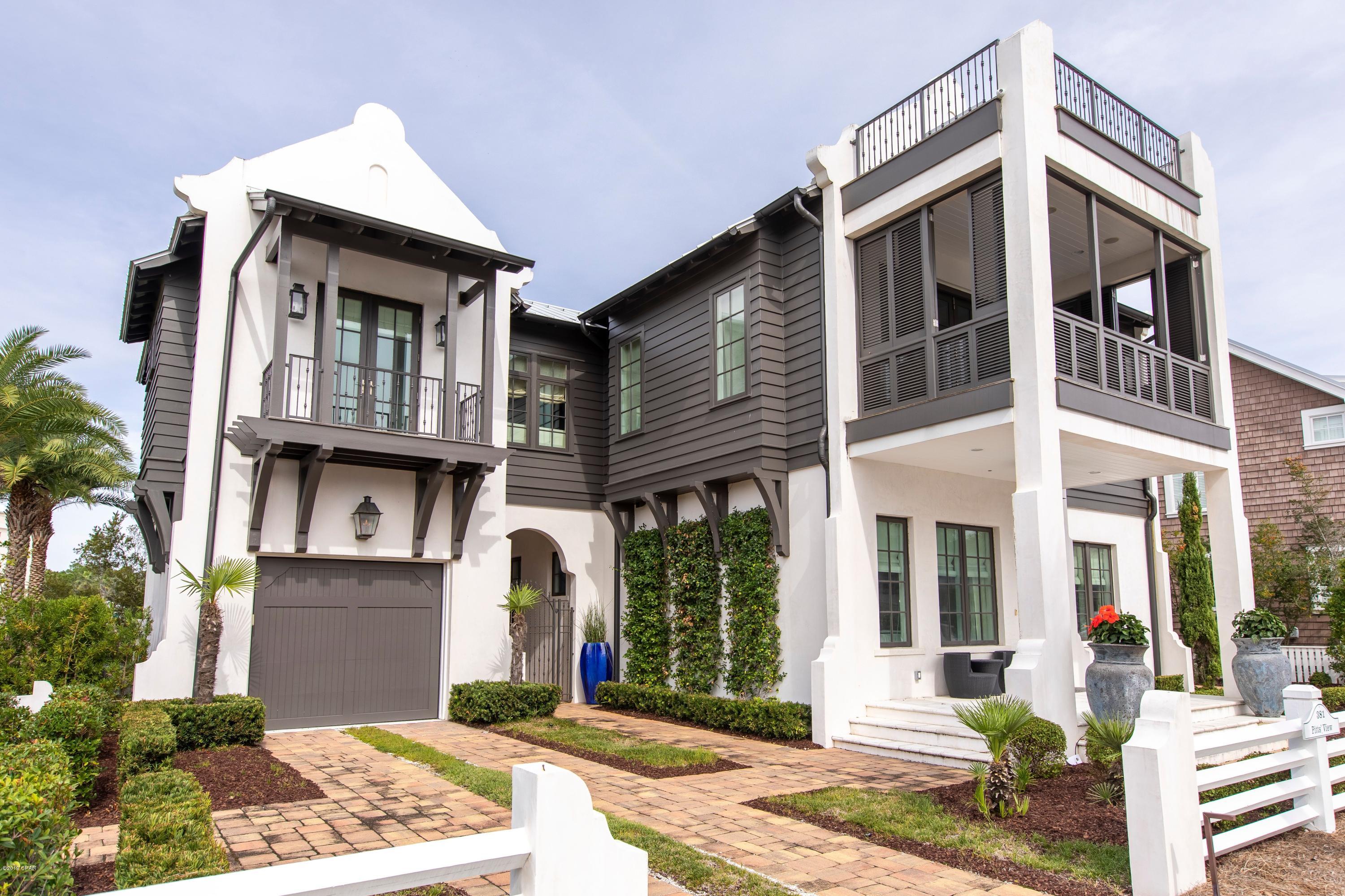Stunning home on Lake Carillon and across Beachside Drive from the Gulf, this property consists of two lots, a large home, pool, garage, and English garden.  There are 4 bedrooms and 4-1/2 baths, a 4-bunk room, a formal living and dining space with beamed ceiling,  a kitchen with outdoor grilling space, and an art studio.   Inside, but adjacent to the pool is a large den and wet bar.  Lakeside is an expansive outdoor living space and pool along with an outdoor shower and powder room.  On the second level, there is an outdoor screened living space off the master bedroom, overlooking the lake, and a large covered, shuttered porch on the front of the living room with Gulf views.  An open deck on the third level looks over the entire community, the lake, and the Gulf of Mexico. WOW