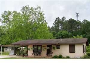 You will just love the charms of country living in this easy on the pocket 2 bedroom 1.5 bath beautifully maintained home. Located just a short 10 minute trip to town off Highway 231 just past Bayou George, this home is a soothing retreat from your busy city life. The large older-style eat-in kitchen leaves you with endless possibilities and opens up to a comfy, casual living room that is a perfect spot for relaxing. The full bathroom is generous enough for bathing and grooming and the master half bath is light, fresh and vintage, with attractive tile accents. In the backyard, an established easy-care garden includes a variety of mature plants from a large shade tree to delightful grapevines. Enjoy your morning coffee under the covered carport or sitting on the front porch swing.