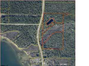 PREVIOUSLY SOLD FOR $300,000 IN 2006, 24.5+- acres ACROSS THE STREET FROM THE EAST BAY, 16 acres of dry land and 8+ acres wet land. BEAUTIFUL POND AND CREEK IN CENTER OF LAND. LOTS OF TREES TO BUILD IN THE SHADE. SEE AERIAL PHOTOS ATTACHED BY CLICKING ON THE MAIN PHOTO. Information taken from tax records and should be verified by buyer. Seller has no knowledge of restrictions etc.