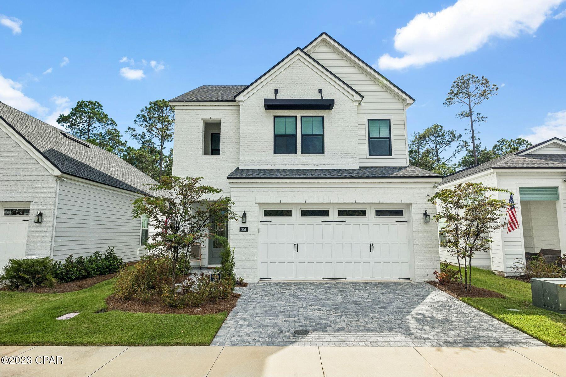 Backing to a natural preserve and distinguished by more than $76,000 in builder-selected options and upgrades, this newly completed 2025 home offers an elevated take on the Hathaway floor plan. As the only finished two-story Hathaway currently available in gated Breakwater at Ward Creek, the three-bedroom, three-bath residence pairs 2,548 square feet with a first-floor primary suite, flex room, spacious upstairs loft and two-car garage.

Inside, an open layout is enhanced by wide-plank LVP flooring extending through the foyer, flex room, great room, kitchen, primary bedroom and closet, main staircase and upstairs loft. An upgraded open-rail staircase adds architectural interest while maintaining the home's light, airy feel. Recessed lighting, dimmer switches and thoughtfully placed electrical upgrades further refine the living spaces.

The kitchen makes a polished statement with Sinclair White cabinetry, Calacatta Miraggio Cove quartz countertops and a herringbone tile backsplash. A Kohler apron-front farmhouse sink, pot-and-pan drawer storage and an upgraded Whirlpool appliance package add both style and function, with a 36-inch five-burner gas cooktop, combination wall oven and third-rack dishwasher among the highlights.

The first-floor primary suite provides a private retreat with a walk-in closet and a richly finished bath. Calacatta Miraggio Cove quartz tops the raised-height vanity while matte-black Kohler fixtures complement a frameless glass shower with full-height tile, a recessed niche and herringbone mosaic flooring. A flex room and full hall bath add versatility on the main level, while two additional bedrooms and a generous loft upstairs provide comfortable accommodations for guests, a media room or secondary living space. The secondary baths feature adult-height vanities with quartz tops and tile surrounds extending to the ceiling, while the laundry room includes additional cabinetry and a quartz countertop.

Designed to extend everyday living outdoors, a 9-by-8 multi-slide stacked glass door opens the great room to a screened covered lanai overlooking the preserve. The lanai is already roughed in for a future outdoor kitchen, making it easy to create a fully equipped entertaining space.

The Breakwater at Ward Creek community offers access to a pool, fitness center, playground, tennis and pickleball courts, along with convenient access to Panama City Beach, Pier Park and the white-sand beaches of the gulf. With its preserve setting, extensive designer upgrades and move-in-ready Hathaway floor plan, the property stands apart as a thoughtfully finished option for both full-time and second-home living.
