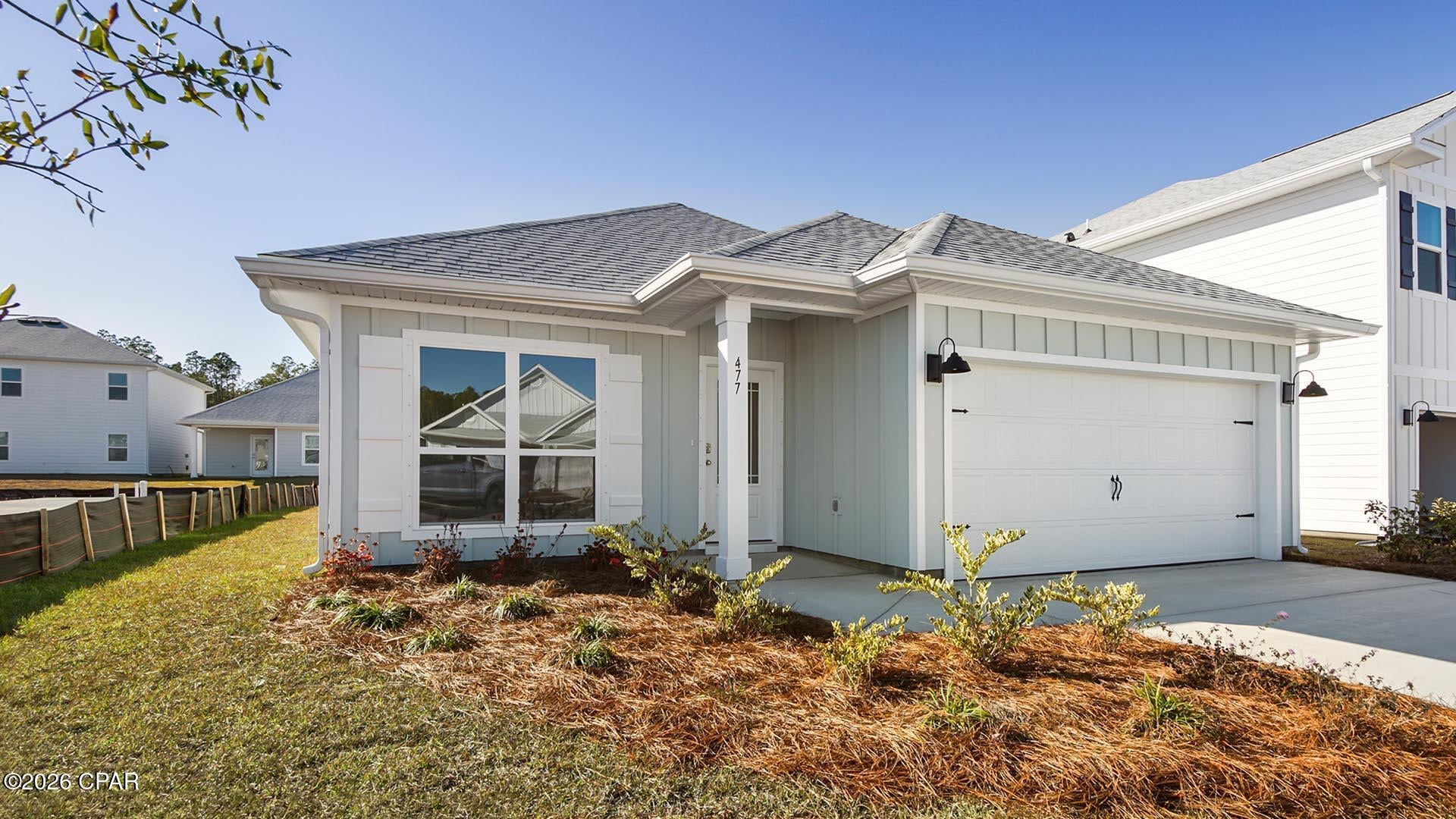 Welcome to 565 Hancock Way, a new home under construction at Bayside at Ward Creek in Panama City Beach, Florida. The desirable Oakley floor plan offers a thoughtfully designed layout with bright, open living spaces and stylish new construction finishes. Just off the foyer, a flexible front room with a large picture window creates the perfect space for a home office, sitting area, playroom, or guest retreat while welcoming natural Florida sunlight into the home. The hallway opens into an impressive open-concept kitchen, dining, and living area, where vaulted ceilings add volume, character, and an inviting sense of space ideal for everyday living and entertaining.

Throughout the home, EVP flooring provides a durable, low-maintenance surface with a seamless modern look. The kitchen is a standout feature with white cabinetry, quartz countertops, and a spacious center island that adds prep space and casual seating.

Privately positioned at the rear of the home, the primary suite includes a spacious ensuite bath with walk-in closet, soaking tub, dual-sink vanity, quartz countertops, lower cabinetry, and separate shower. Two additional bedrooms are located near the full guest bathroom, linen closet, and convenient laundry room with shelving above the washer and dryer hookups. A full-glass back door connects the living room to the covered back patio, creating an easy indoor-outdoor flow for relaxing, grilling, or entertaining.
