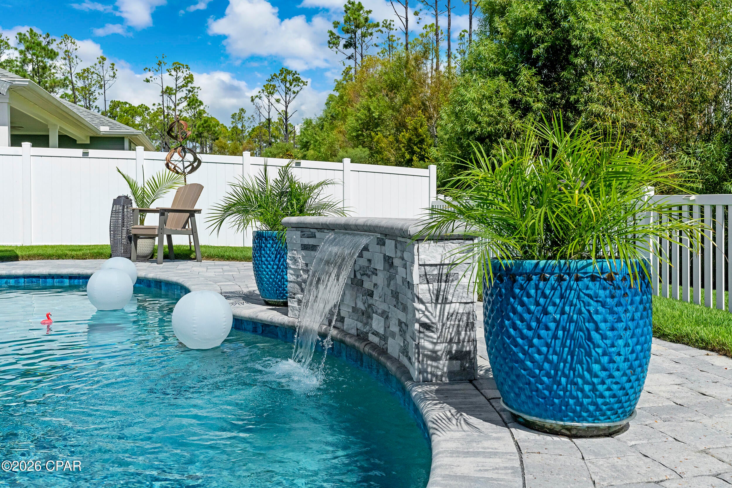 Space to relax outside, room to spread out inside, and a wooded backdrop beyond the backyard give this Breakfast Point home a lot to appreciate. A private gunite pool and covered, screened patio make the outdoor space especially inviting, while the 3BR/2BA Mako floor plan by Samuel Taylor Homes provides an easy, comfortable layout inside.

With no neighbors directly behind, the backyard looks out to trees rather than another home, creating a natural sense of privacy and a tranquil view from the pool and porch. Double French doors open from the main living area to the screened porch, making it easy to move between the two and letting the outdoors become part of everyday living. 

Inside, the home has a comfortable sense of scale, with 10' ceilings, crown molding, and trim around the windows in the main living areas adding character and detail without making the spaces feel overly formal. LVP flooring runs through the foyer, living areas, kitchen, dining area, and laundry, with plush carpeting in the bedrooms and tile in the bathrooms. The kitchen keeps everyone connected, with an open layout that flows naturally into the dining and living spaces, complemented by quartz countertops and stainless appliances.

The primary suite offers a comfortable place to retreat at the end of the day, with a walk-in closet, double vanities, and a walk-in shower. The split-bedroom layout places the guest bedrooms on the opposite side of the home, giving the primary suite a little more separation while providing comfortably sized rooms for family, guests, or a home office.

Several improvements made by the owners add to the home's functionality and long-term care. The garage floor and both the front and back porches have been finished with a durable polyurea coating, while an underground downspout extension in the backyard directs water away from the house. A termite bond is also in place. The two-car garage provides convenient space for vehicles, storage, and the extras that come with life near the beach.

The home exceeds standard hurricane construction requirements with 2x6 exterior wall framing, a hurricane tie-down rod and anchor system, architectural shingles, and higher insulation ratings. These are the less visible details that add value to a home long after the finishes catch your eye.

Beyond the property itself, Breakfast Point offers a lifestyle that balances neighborhood living with the convenience of Panama City Beach. Sidewalks, parks, walking trails, and golf-cart-friendly streets make it easy to get around the community, while Breakfast Point Academy, Publix, dining, Pier Park, Frank Brown Park, and the beaches are all just minutes away. It is a setting where everyday errands, afternoons outdoors, and time at the beach can all fit naturally into the same day.

For those looking for a Panama City Beach home, this one offers a particularly enjoyable way to live here. Call today to schedule a private viewing.