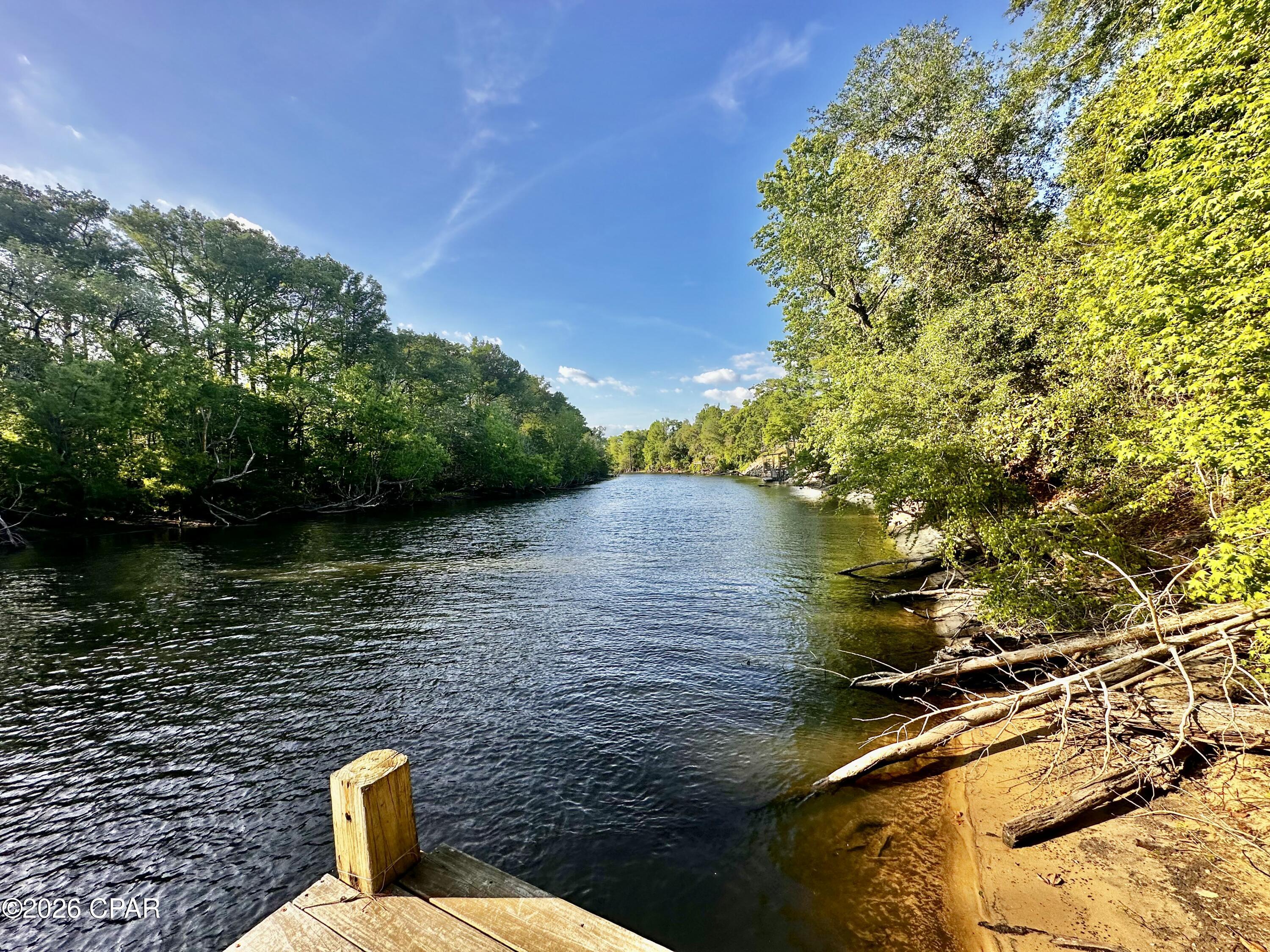 Half acre waterfront lot on the Chipola River in the Scotts Ferry area. This tranquil waterfront parcel already includes essential infrastructure, with a new power pole, a well, and a septic system in place. A brand-new pole barn provides immediate storage or workshop space, and a dock offers convenient river access for boating and fishing. With scenic water views and plenty of room to design your dream, this is a prime canvas for a weekend getaway or a full-time waterfront home.