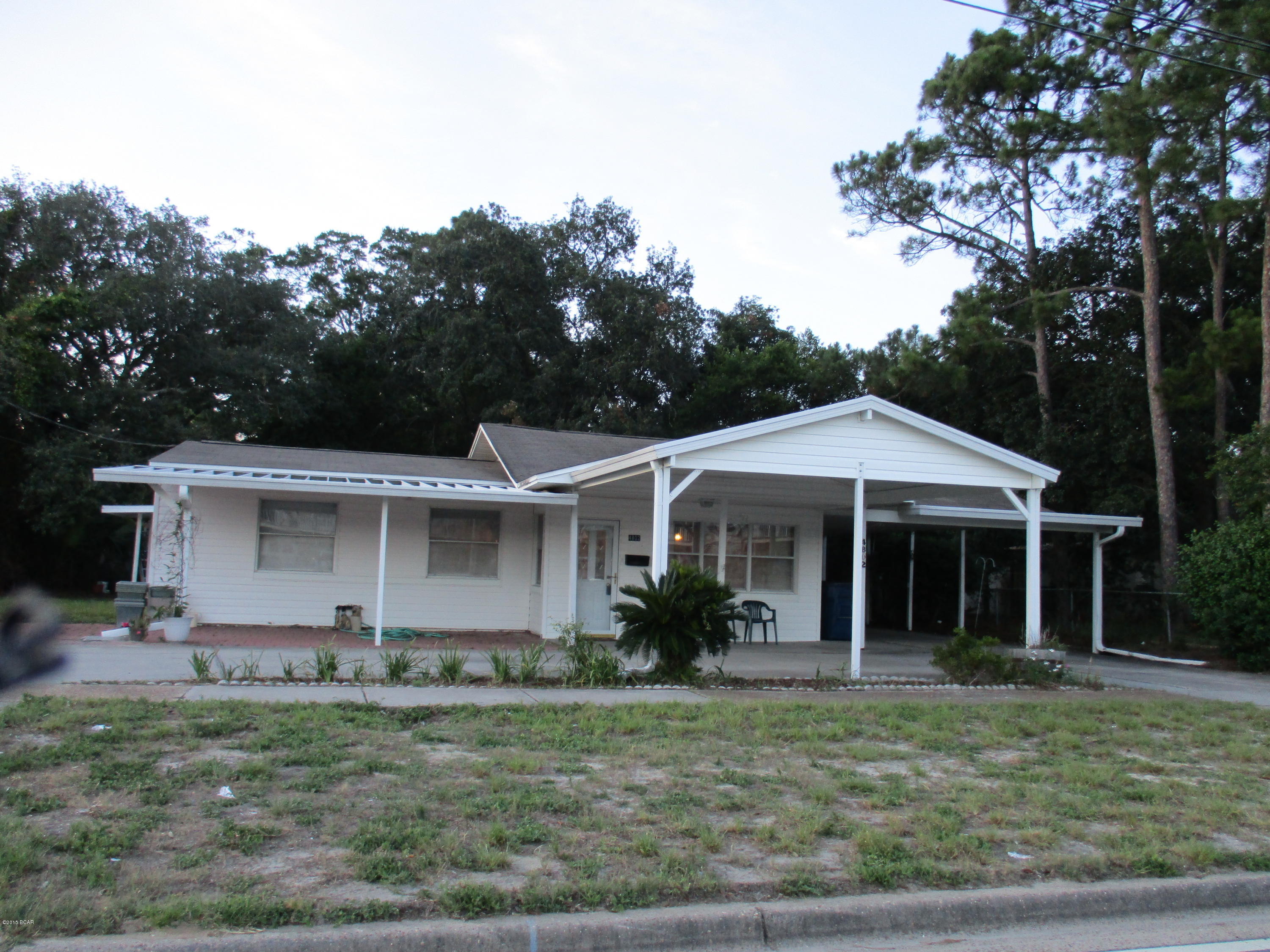 Affordable 2/1 home near the college. This home features plenty of parking with 2 carports, circle drive and paver driveway. Enter from the foyer into the large dining room through double french doors to the fully equipped kitchen with loads of cabinets and breakfast bar. Spacious living room with a brick hearth and fireplace. Leading from the kitchen to a 27x16 florida room with storage cabinets. An added plus going through double french doors to a 26x16 game room. Also included is a 30x18 open deck and 18x10 workshop and garden room.  This property has so much to offer for such an affordable price.  Located near the Hathaway bridge leading to Panama City Beach.  Centrally located to all your needs.