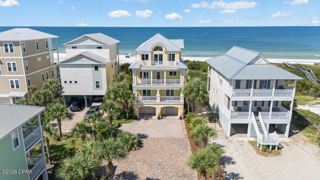 Luxury Estate Home on a large gated Gulf-front homesite offering exceptional privacy, scale, and timeless coastal elegance. Meticulously maintained as a cherished family retreat, this extraordinary residence has never been rented and offers a level of care, condition, and custom quality rarely found in today's luxury coastal market. Custom built by Windolf Construction and positioned on two combined lots--a Gulf-front lot plus an additional 1st-tier lot--this estate-sized property encompasses 5,000+ heated and cooled sq ft and more than 8,000 sq ft under roof including expansive decks, all designed to capture unobstructed Gulf views and sweeping Bay views to the east. The home features 5 bedrooms, 6 full baths, and 1 half bath, with each bedroom offering a private ensuite bath and deck access. Soaring ceilings, walls of glass, a fireplace, and expansive open living spaces create a dramatic setting for entertaining. The chef's kitchen is appointed with high-end appliances, custom cabinetry, a butler's pantry, and generous dining areas designed for hosting on a grand scale. Multiple living and dining spaces open onto spacious Gulf-front decks for seamless indoor-outdoor living. A private elevator services all levels, including the spectacular top-floor primary suite retreat spanning more than 1,800 sq ft. This private sanctuary features a sitting room with Bay views, a Gulf-front deck, and a spa-inspired bath with soaking tub, walk-in shower, and custom cabinetry. The oversized two-lot setting offers exceptional outdoor space with room to add a private pool, while the flexible floor plan presents the opportunity to create a 6th bedroom or additional bunk/flex space. Located on a quiet stretch of beach just steps from the neighborhood pool, this legacy Gulf-front estate is a rare opportunity to own one of Cape San Blas' most private and distinctive luxury properties.