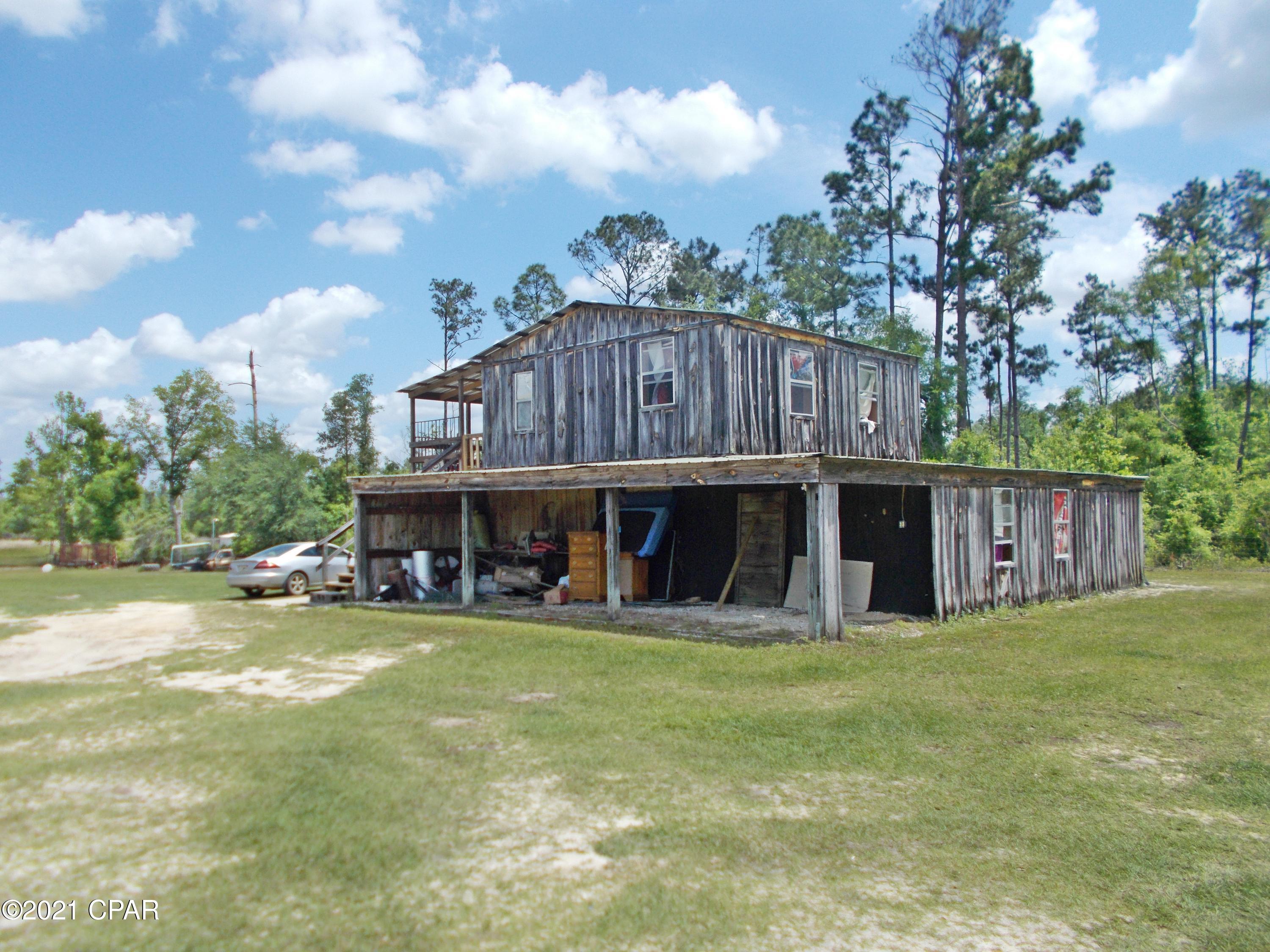 Amazing opportunity for the family, this quite county setting has 3 homes on it, a wood frame two story dwelling and 2 mobile homes, 4 stocked ponds 3 septic tanks 2 wells,3 barns one has a shop car lift, the land is cleared with plenty of room for farm animals or a garden, this is a very unique place and is located just south of town, all on over 8 ac.