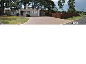 **THIS IS A HOME AND A VACANT LOT** This is a move-in ready, immaculate home close to the beach and lagoon! The home is situated on a double lot and has been updated in recent years. The kitchen includes granite counters and all Frigidaire stainless steel appliances. You'll love the huge pantry where you can store all your food items as well as your small appliances. The Schwinco windows throughout the home are impact-rated and non-impact vinyl which are sure to give you peace of mind. The home features a split-bedroom floor plan and the Master Suite includes three closets with lighting and an en suite with a walk-in shower and a bidet. The back patio is the perfect place for dining al fresco with pretty landscaping and accent lighting. The backyard is privacy-fenced and the seller