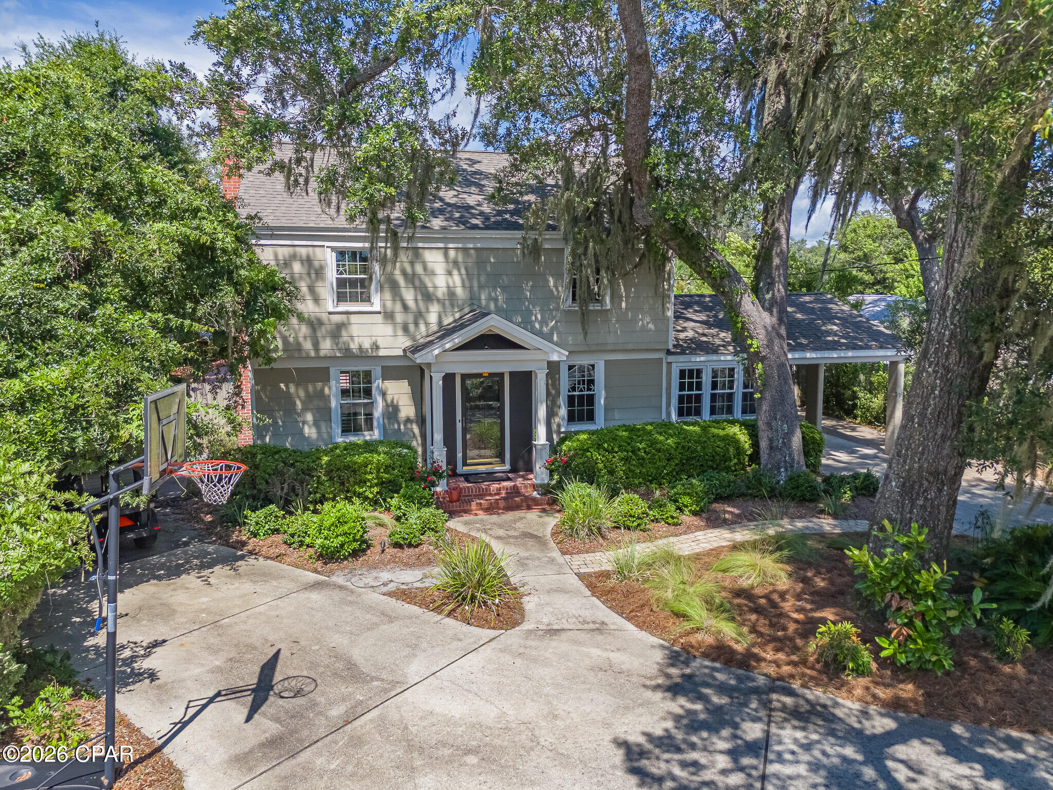 CURRENTLY UNDER CONTRACT, SELLER ACCEPTING BACKUP OFFERS Welcome to 427 Bunkers Cove Road, an exceptional coastal residence located in the highly sought-after Cove neighborhood of Panama City, just moments from St. Andrews Bay and around the corner from the St. Andrews Bay Yacht Club. This prime location offers the perfect blend of waterfront living and convenience, with downtown Panama City, restaurants, shopping, and local attractions only minutes away.
Offering approximately 3,576 square feet of thoughtfully designed living space, this beautiful Colonial Revival home features 4 bedrooms, 3 full bathrooms, and timeless architectural character throughout. The inviting two-story design showcases a symmetrical façade, welcoming columned portico, classic brick chimney, and mature live oak trees draped with Spanish moss, creating unforgettable curb appeal.
Inside, you'll find a spacious and functional floor plan enhanced by hardwood flooring, abundant natural light, divided-pane windows, and stainless steel appliances. The chef's kitchen flows seamlessly into the main living areas, making it ideal for everyday living and entertaining. A bright sunroom overlooks the backyard and provides the perfect space to relax year-round.
Upstairs, a hidden bonus/game room tucked off the fourth bedroom offers endless possibilities as a media room, playroom, home office, or guest retreat while enjoying views of the pool and backyard.
Step outside to your own private oasis featuring an in-ground swimming pool, spa, beautifully landscaped grounds, and multiple areas for entertaining or unwinding. Alley access provides ample parking for a boat, RV, or camper, while the large detached workshop offers outstanding space for storage, hobbies, or recreational equipment.
Additional features include a whole-home water filtration system, covered side carport, established landscaping, mature shade trees, and a golf cart-friendly neighborhood that enhances the relaxed coastal lifestyle.
Combining timeless architecture, modern comforts, generous indoor and outdoor living spaces, and an unbeatable location, 427 Bunkers Cove Road presents a rare opportunity to own one of Panama City's most distinctive homes. Schedule your private showing today and experience everything this exceptional property has to offer.