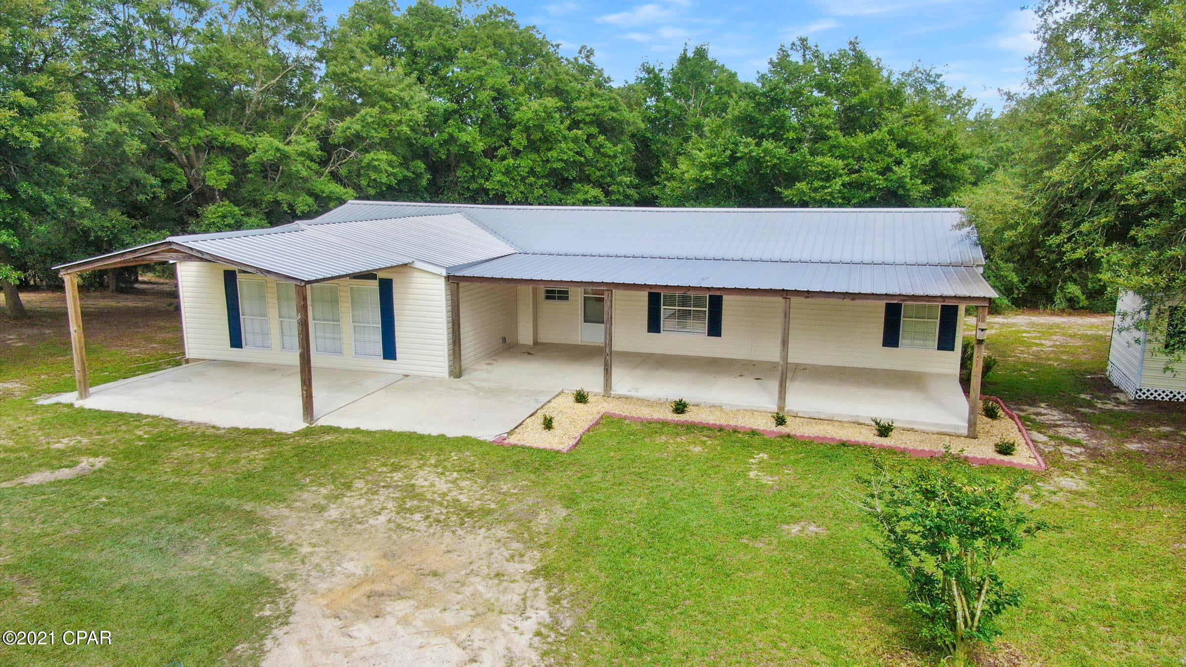 Multiple Offers - Highest and Best Due By 5:00 pm 07/02/2021. Ready for some space to just breathe? This property has everything you need and more. Just half a mile from Highway 77 and 20 minutes from Lynn Haven, you will find this quiet 2.7 acre property with beautiful views and a pond! Need more? You got it. Less than half a mile away is the private boat slip, pavilion, and beaches on Grassy Lake, all maintained by the HOA for only $200 a year. The home has a split floor plan with two living rooms and a wood burning fireplace. There is a large kitchen with a walk in pantry and large laundry area with its own exterior door. The master bedroom has a double vanity, walk in shower, and large walk-in closet.  Outside there is covered parking in the front, covered storage in the back, and an extra storage building.The covered front porch is over 400 sqft overlooking serene horse pastures. In the backyard you will find an additional 300 sqft covered porch that is completely secluded and surrounded by mature trees you don't find often. The home has been well maintained with the septic system recently updated and a roof only five years old. You can just move in and enjoy this amazing home. 

This home and property are rare finds. Do not miss your opportunity.